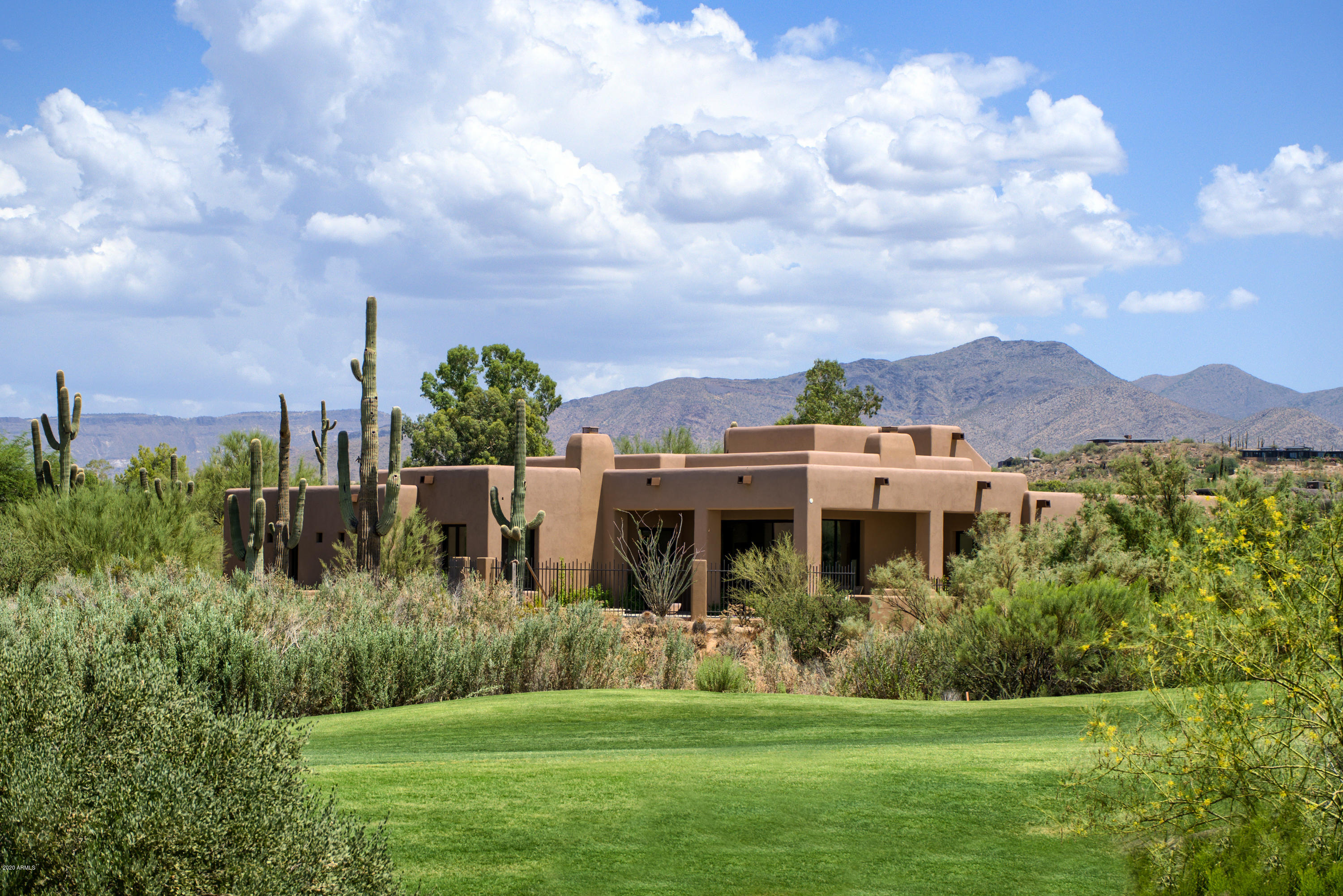 NEW Home on one of best lots in The Estates at  The Boulders. Spectacular setting, views of ''Landmark'' Boulderpile. Also mountains & two fairways. A pristine and private Desert Sanctuary. Versatile & open...provides effortless entertaining & casual family living. Rooms flow to outdoors. Materials & colors blend with setting. Secluded Master, luxurious bath.  3 en-suite guestrooms with private patios. Office and media room. Dramatic high ceiling, beamed Great room with fireplace - joins terrific kitchen-all opening to patios, pool and fabulous outdoors. Views from every room. Timeless finishes. Exceptional custom cabinetry & doors, select wide-plank wood floors, beautiful stone counters & vanities.  Shop/Hobby room-with  A/C. Home designed for desert and energy efficiency. Gated Community