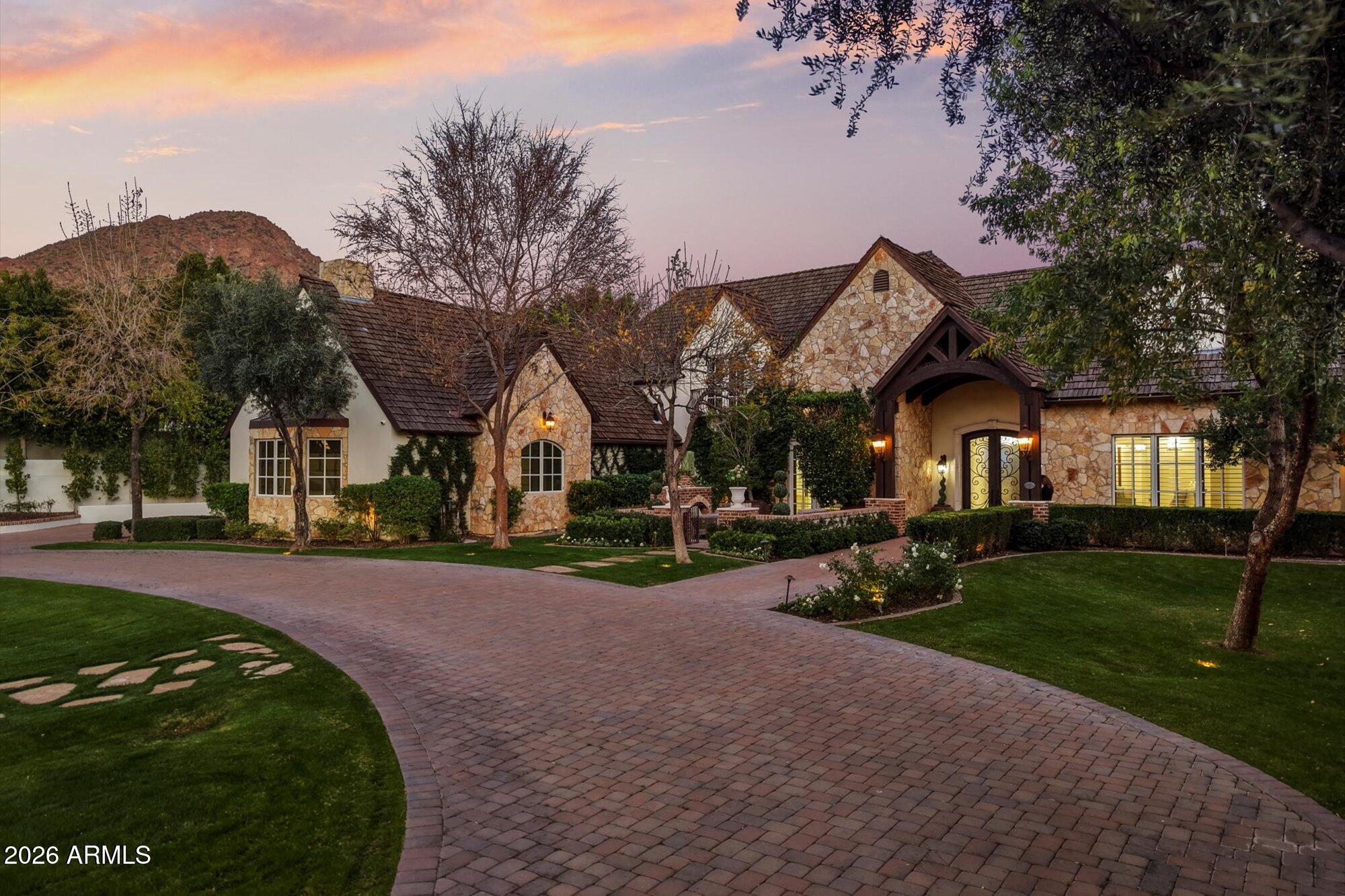 Located on a premier street in the Heart of Arcadia Proper, this charming estate, on over an acre lot, features 6 bedrooms, 8 bathrooms and nearly 8,500 Sq Ft livable! This property truly checks every box! Upon arriving, you are welcomed by gorgeous curb appeal and mature landscaping, a cozy front patio with fireplace & oversized 4 car garage + large storage room! The light and bright open floor plan has a spacious kitchen with marble countertops! The main level primary suite features incredible Camelback Mountain views, sitting room with a built-in second office, gorgeous marble bathroom with soaking tub and dual walk-in closets. The upstairs features a spacious loft, kids homework area, second laundry room, gaming room, & 3 full ensuites! Featuring one of the best backyards in Arcadia, with an outdoor kitchen, diving pool with a baja shelf, spa, fountains, putting green, sport court, citrus trees, walking paths and a large grassy backyard with a rose garden!