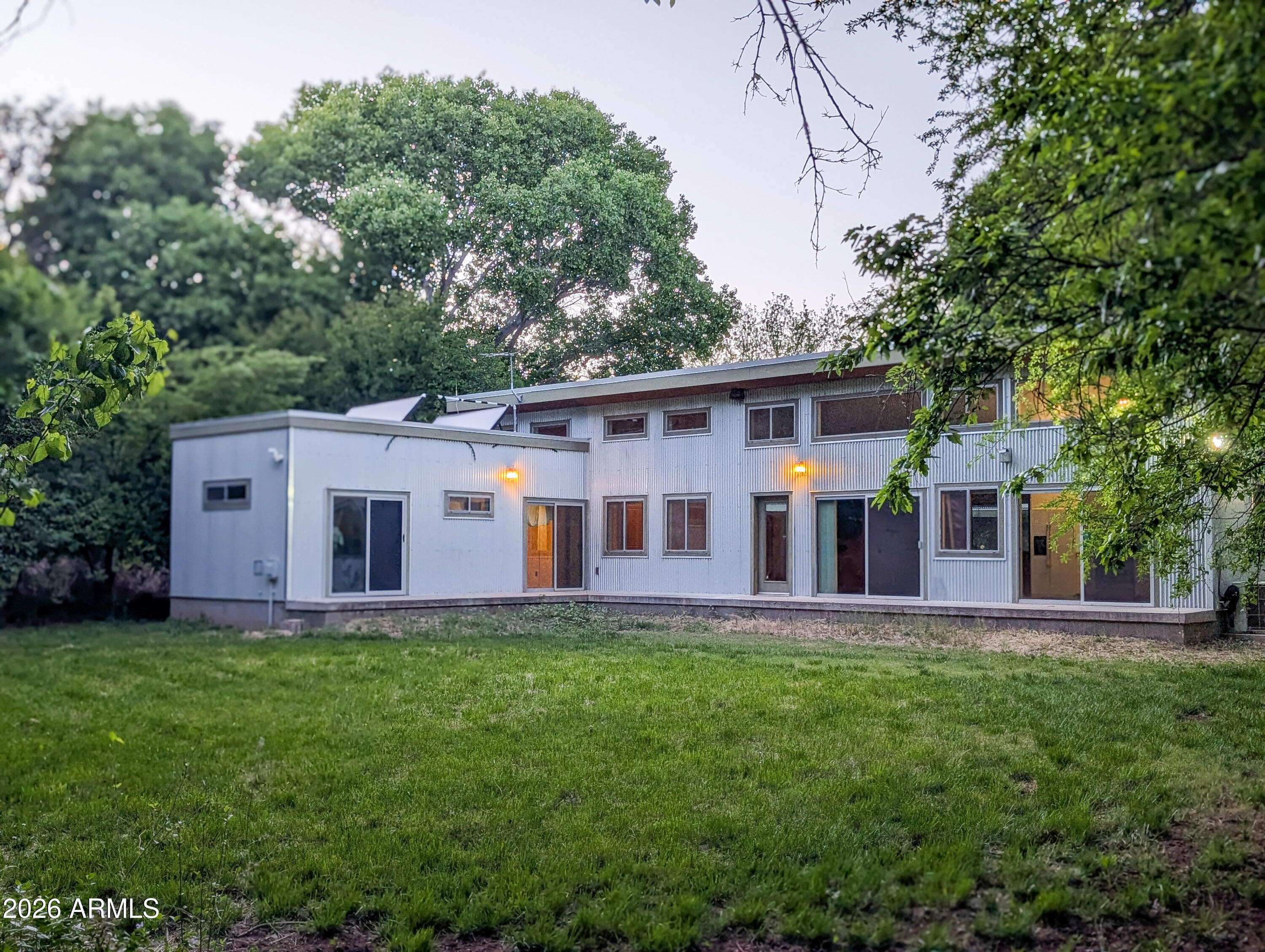 Property Summary: In the Heart of Old Town Cottonwood. 6.8+ Acres | 3BR/2BA Main House | Full Guest Suite | Solar Owned | Grandfathered Irrigation Rights | Bordering State Park | Horse Property. No HOA.
You won't find another property that offers this much and yet is so close to everything. This is a rare opportunity to own a private piece of the Verde River greenbelt
The Location: Heart of Old Town Cottonwood
Experience the ultimate ''hidden in plain sight'' location. While the property feels like a remote rural escape, you are:
Minutes to the River: A quick 2-minute stroll puts you at the banks of the Verde River for kayaking, fishing, or cooling off.
Old Town Walkability: Just a 6-minute walk leads you to the tasting rooms, boutiques, and world-class dining of historic Old Town Cottonwood.

Trail Access: Step off your property and onto the Jail Trail or nearby state land paths.
Sedona Proximity: Enjoy the Red Rocks of Sedona, just a scenic 15-minute drive away.
Equestrian Potential: Perfect for horse lovers, with ample space, accessible trails and abundant water.
The Land: A High-Yield Producer
Fed by the historic Cottonwood Ditch with full irrigation rights, this property is engineered for the serious grower or equestrian:
The Orchard: Over 100 fruit and nut trees, including peaches, apricots, apples, figs, persimmons, and pecans.
The Vineyard Setup: 450 blackberry bushes meticulously trellised in a vineyard style for easy harvest.
The Garden: A large, fenced garden area that has provided a bounty of organic vegetables for years.
Privacy: The yard is filled with a variety of mature trees and shrubs - including magnolias and pecans - creating a completely private and tucked-away atmosphere.
Private Boundaries: Backs to State Land and remains "tucked back" from the street for total privacy.

The Residence: The 3-bedroom, 2-bathroom main home is a study in modern efficiency, prioritizing for natural light. Main residence has modern efficiency and an open-concept. 
Eco-Design: A true passive solar home featuring large southern windows that warm the richly finished concrete floors during winter months.
Energy Independence: Equipped with an owned solar panel system on the garage and a solar hot water heater.
Walls of light: Massive windows frame stunning views of the Greenbush trees and your own vibrant green acres.

The Casita: A separate Casita is perfect for a high-performing Airbnb or a private guest house.
Fully Equipped: Includes a full kitchen and private washer/dryer.
Relaxing Views: Features a covered porch with calming views of the surrounding greenery.
Income Ready: With its private feel and proximity to town, this is an ideal short-term rental or Airbnb setup.