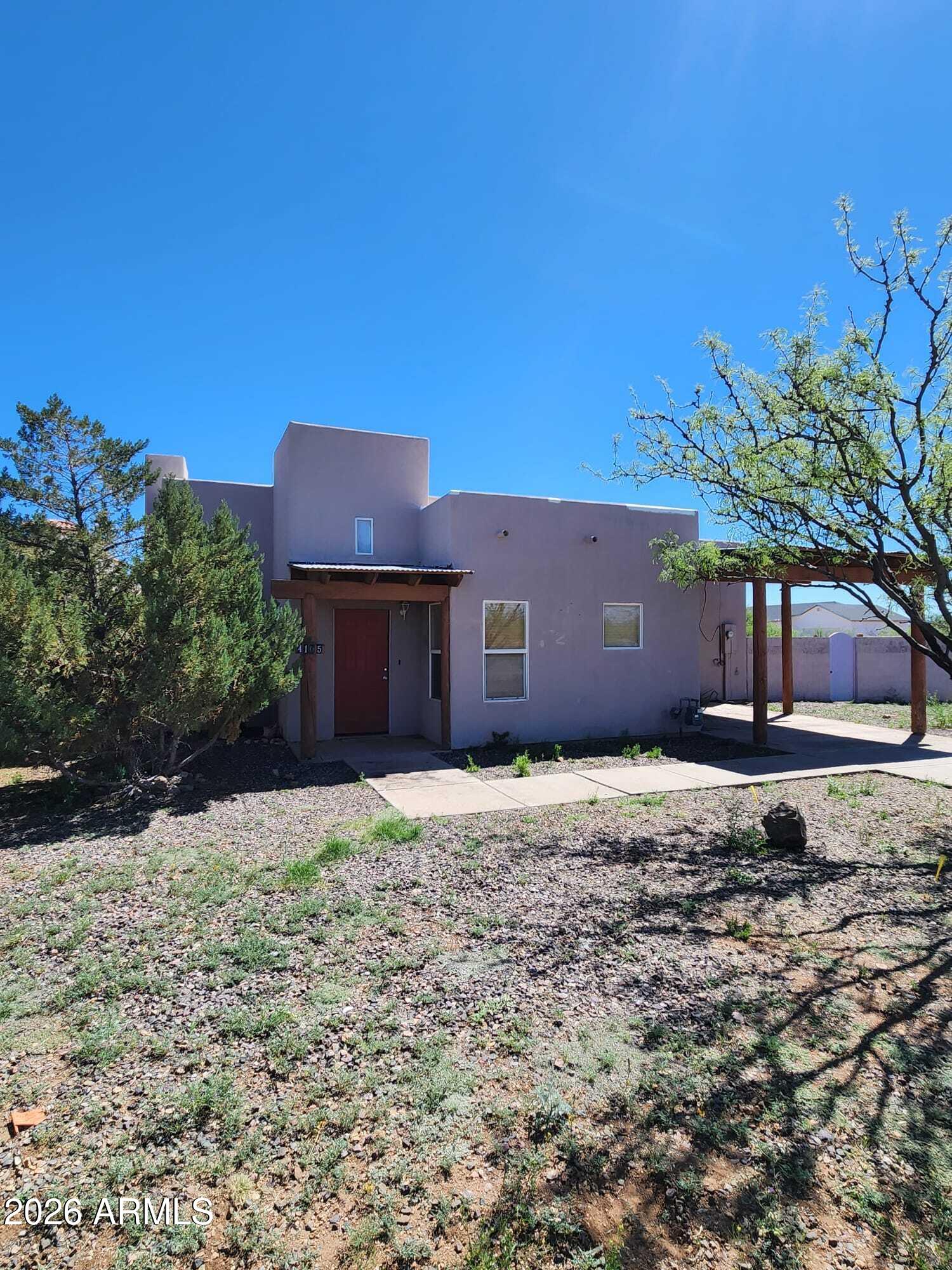 Santa Fe style home with beautiful wood beams, spanish style tile throughout the house. 3 bedrooms 2 full bathrooms, carport and block- fenced patio. Nicely maintained in a quiet neighborhood. Priced to sell!