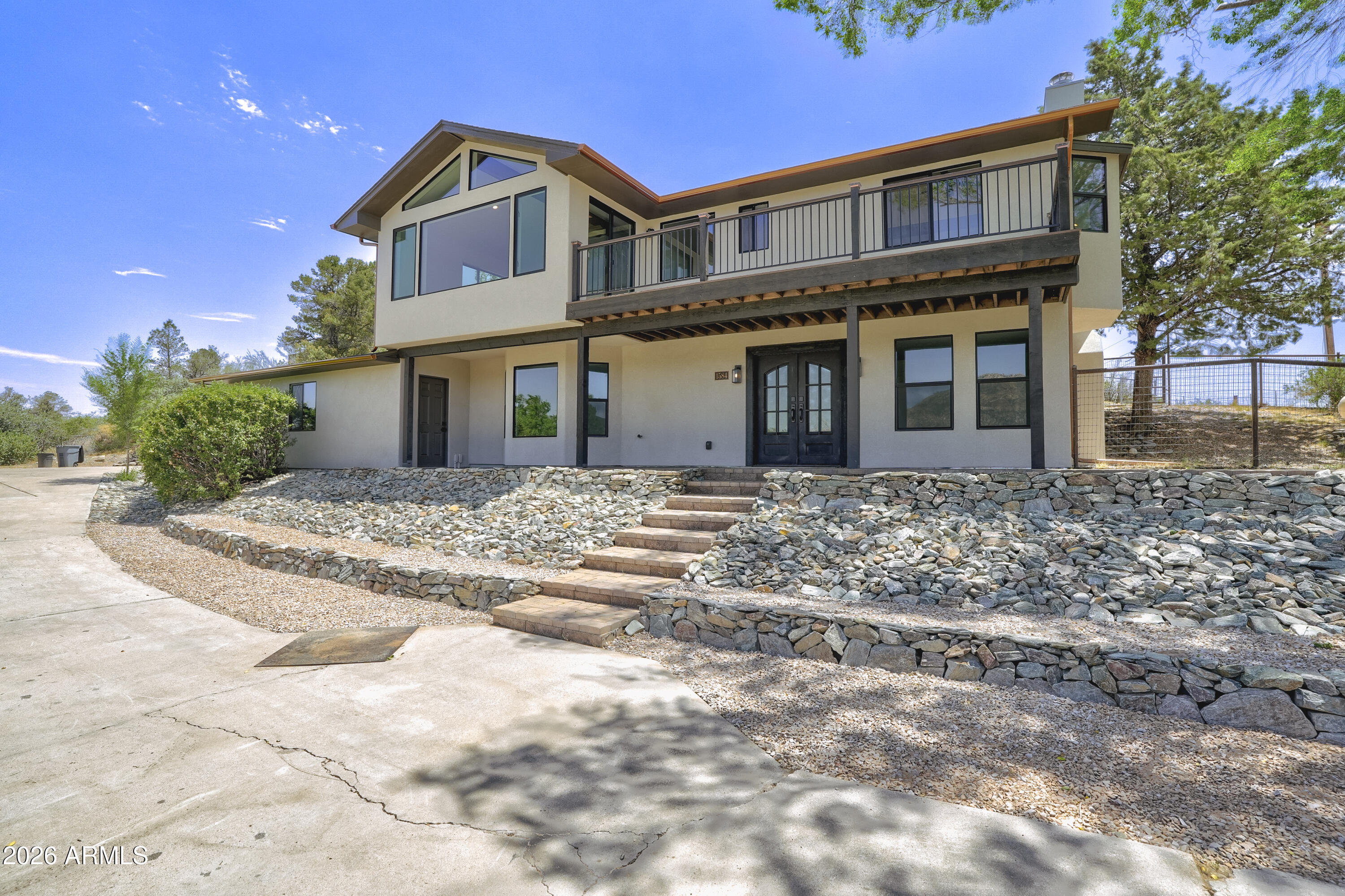 Welcome to 1584 West Cliff Rose Road, where peaceful Prescott living meets comfort, space, and the Arizona equestrian lifestyle. This home has been almost completely redone . . . from top to bottom. Too much to list - See attached Upgrades and Features List. Set on 2 acres, this ranch-style home offers something that's becoming harder and harder to find -- room for you, your animals, and the lifestyle you've been dreaming about. You'll notice beautiful surroundings, and a property designed to take advantage of everything Prescott has to offer. Step inside and you'll find a warm and inviting home filled with natural light, comfortable living spaces, and beautiful views right outside your windows. The Great Room was designed for everyday living and the Chef's kitchen offers plenty of space to cook, entertain, and stay connected with the heart of the home. With 3 guest bedrooms and three bathrooms, the layout gives you flexibility for guests, hobbies, or a quiet space to work from home. The large primary suite offers a peaceful retreat to enjoy the view or can relax and unwind at the end of the day. Designed with the horse owner in mind, you'll find a 4-stall MD barn, paddocks, custom fencing, an arena, and plenty of room for your horse trailer and equipment. A plus for horse owners - property is within riding distance to Pioneer Park and State Land. The property is set up so you can enjoy your horses right from home -- whether it's an early morning ride, evening chores, or simply enjoying the view from your own backyard. Spend your mornings with coffee on the patio, watch the sunsets, enjoy the wildlife, and take in the peaceful surroundings that make Prescott such a special place to live. With space, privacy, views, and a complete horse setup, this isn't just a home... This is the Prescott lifestyle.