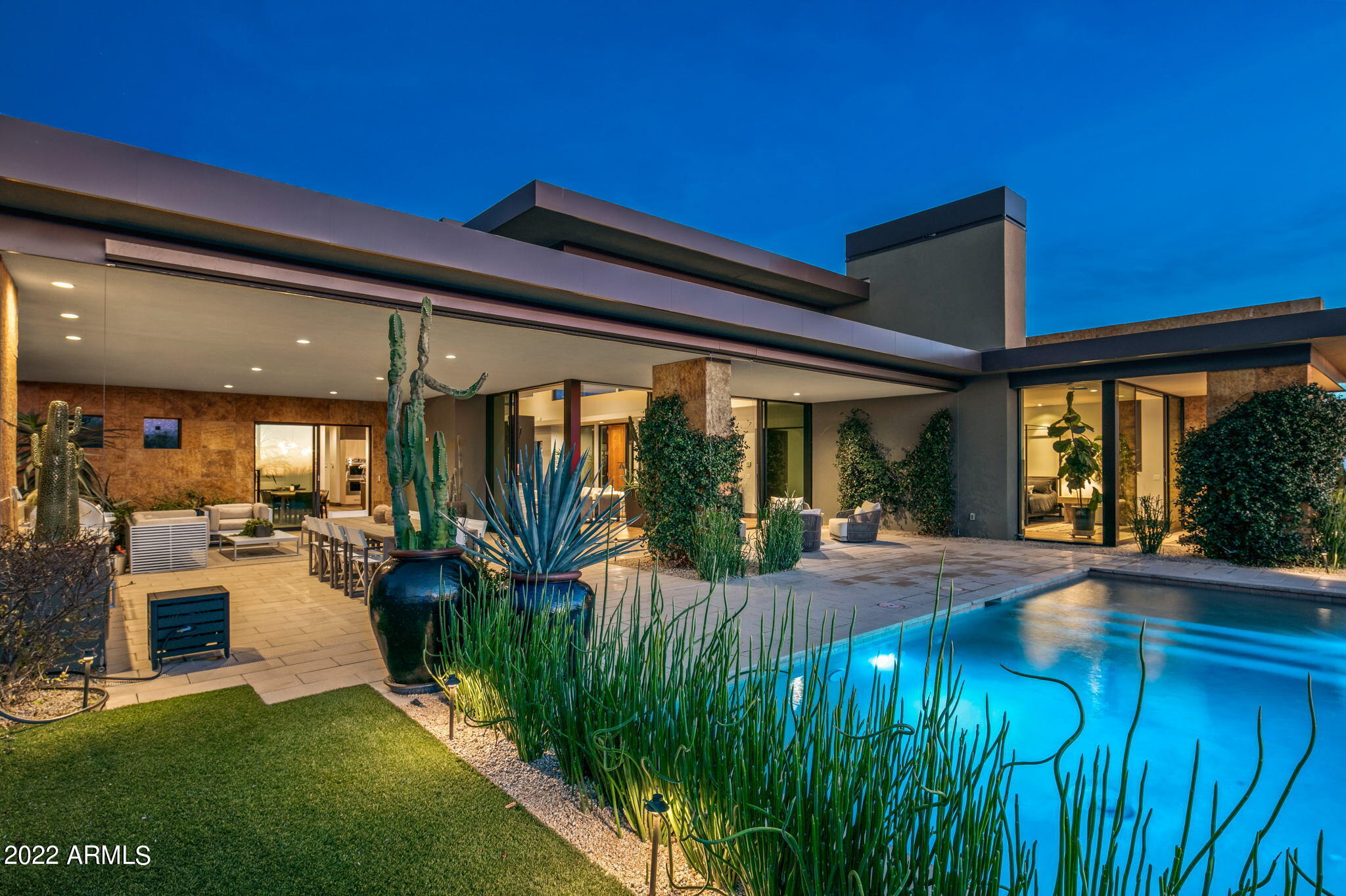 Fabulous desert contemporary home designed by renowned architect Ron Brissette. Floor to ceiling glass is everywhere captivating the majestic continental mountain views, city lights and sunsets. Giant corner retracting doors in the great room opens the entire house to the gorgeous backyard and covered patio area. Top of the line appliances, cabinetry, and finishes were selected to complete this home. Lutron low voltage one touch lighting controls and automated shades are included as well. Who is going to be the lucky one to call it home? Hurry. Won't last at this price. The light fixtures in the dining room, kitchen island and casita do not convey. Mirror in casita, architectural landscape spheres, fountain and planters do not convey.