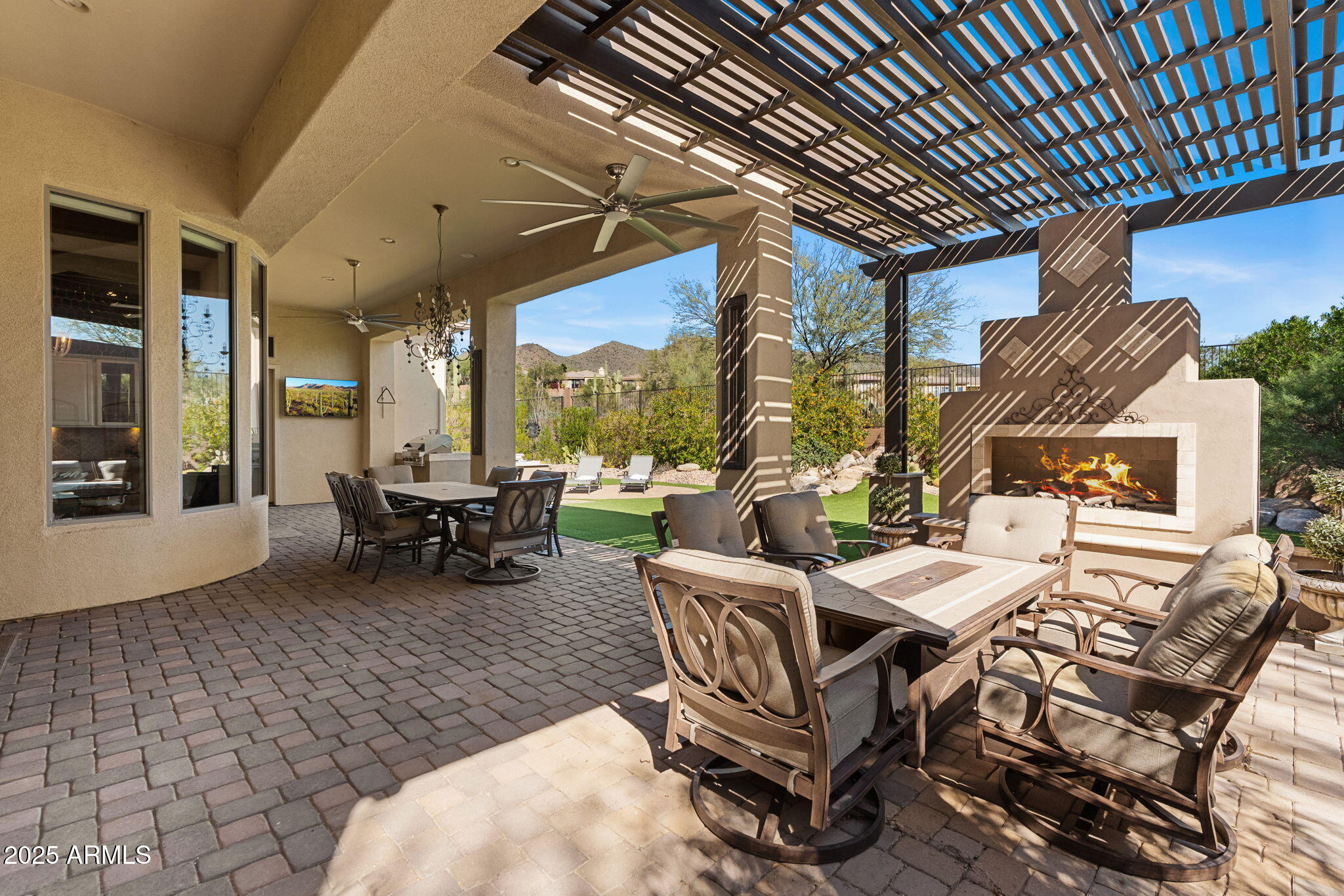 Welcome to the Guard-Gated Anthem Country Club Community! Beautiful Catalina model with 2 en suite bedrooms, den with French doors + built-in bookshelves & 3 baths. (Hall bath has shower.) Dramatic12-foot ceilings with wood beams. Great Room floor plan with gas fireplace. Updated kitchen with granite counters, stainless appliances, painted raised panel cabinets with new brass hardware and custom-built dining table designed specifically for the space. Private backyard to open space views, extended patio, pergola, gas fireplace, above ground & submerged spa, soothing water feature & built-in BBQ! 3-car garage with epoxy floor, built-in cabinets, central vacuum, newer water heater, filtered drinking water & water softener! Closet may be added to den to make a 3rd bedroom.
