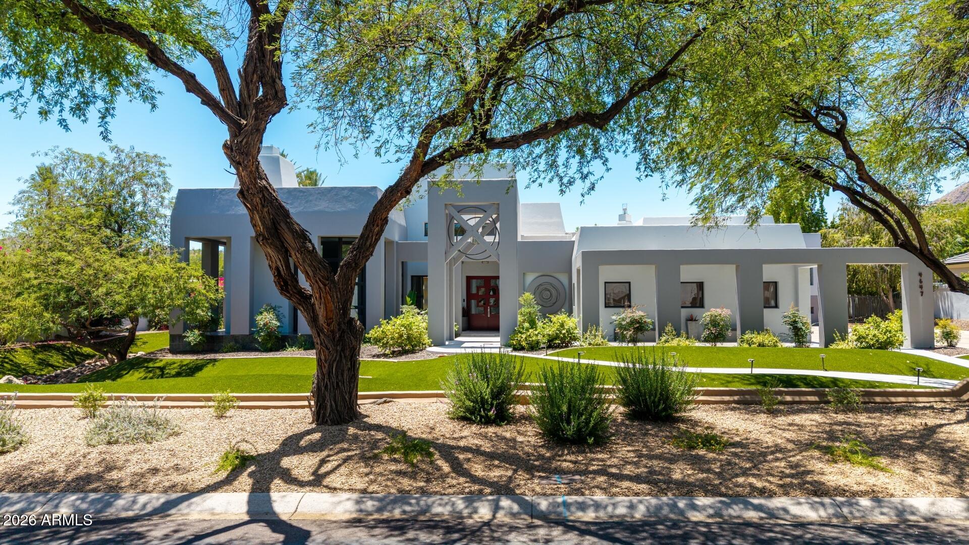 Experience luxury living in this stunning 5,000 sq. ft. residence situated on a premium corner lot in Tatum Foothills, one of the most sought-after gated communities in the Paradise Valley area. Located in the coveted 3C's school district, this exceptional home features 3 spacious bedrooms plus an office and 4.5 baths.  Inside you are met by a grand foyer, and dramatic circular office with floor-to-ceiling windows that creates the perfect executive workspace. Entertain in style with a formal dining room showcasing a 350-bottle climate controlled wine wall, a contemporary chef's kitchen with matching Thermador appliances, and a beautiful modern bar in the expansive family room. The private second-floor primary retreat offers direct access to a bridge leading to the resort-style backyard oasis, complete with a sparkling pool and spa. An additional two ensuite bedrooms offer a private space for other family members or guests.  This home is a rare blend of sophistication, design, and indoor-outdoor living.  It was a featured home in the popular Street of Dreams publication.