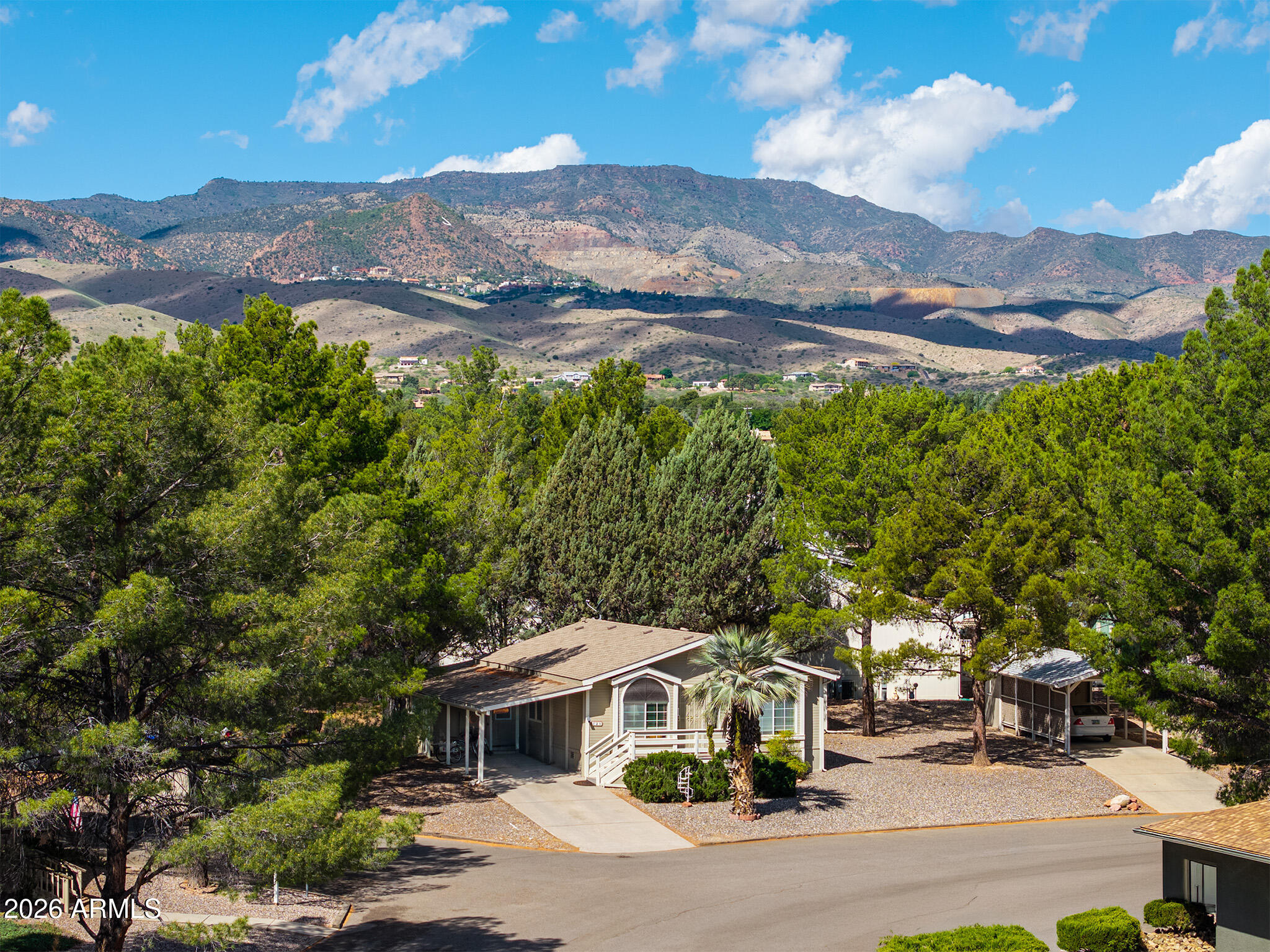 Peacefully nestled among beautiful mature trees w/ Majestic Mingus Mountain & Jerome set as a breathtaking backdrop, this gorgeously designed 2-bedroom home offers the ultimate in comfort. Perfectly situated in Pine Shadows, a premier 55+ resort-style community, this home features a welcoming front entrance, a beautiful front-yard palm tree & stylish flooring updated in 2022. The spacious kitchen features ample cabinetry, a refrigerator & dishwasher. Ceiling fans included thruout. Laundry room w/ washer/dryer. Spacious AZ room & a workshop/shed for extra storage. Enjoy a vibrant lifestyle w/ top-tier amenities, including an indoor pool, fitness center, pickleball & bocce ball courts, a library & a calendar full of social events. Your paradise awaits!