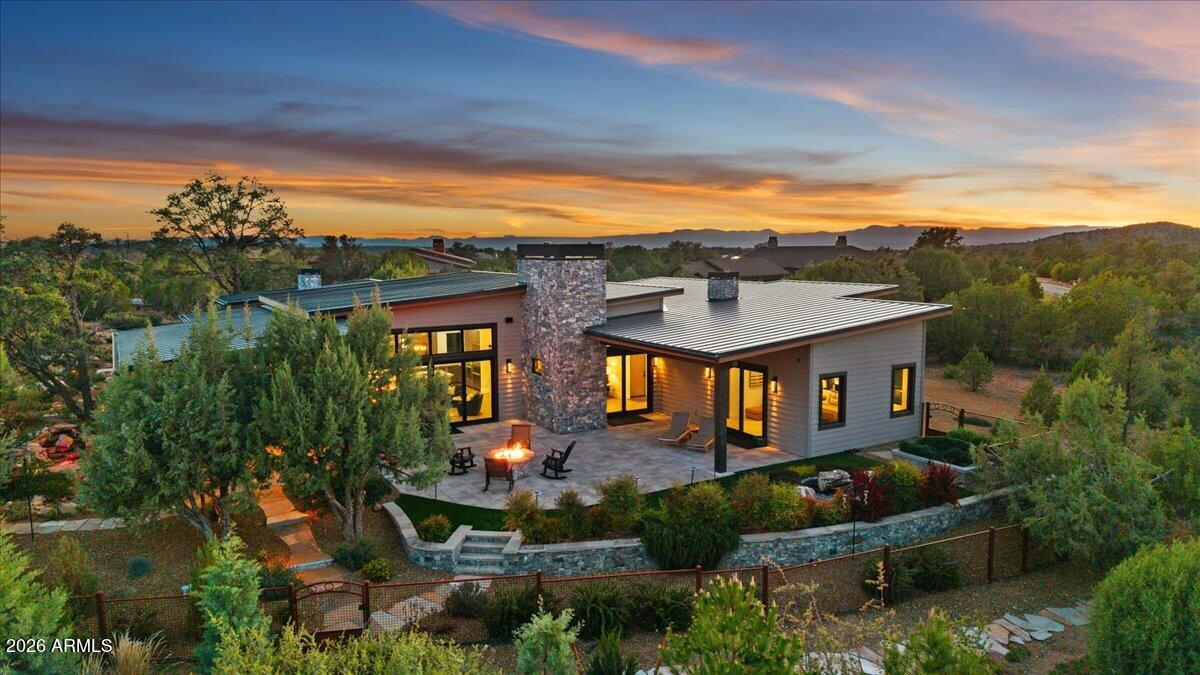 Experience this Beautiful Architecturally Refined Mountain Contemporary with incredible attention to detail, quality construction & curb appeal. Designed to capture breathtaking mountain views blending indoor comfort with outdoor living. Chef's kitchen anchors the space with European luxury cabinetry ,15' quartzite Island counter, room for 7 barstools, hidden pantry & premium Thermador appliances. Primary suite offers a spa-like retreat with a walk-in shower, freestanding Duravit soaking tub, dual vanities & his-and-hers closets. The split floor plan includes 2 guest suites, with ensuite baths & a private guest patio. Private 1.06-acre sanctuary of lush outdoor vegetation including wrought iron fencing, 2 tranquil water features & Large outdoor patio space for relaxation & entertaining.