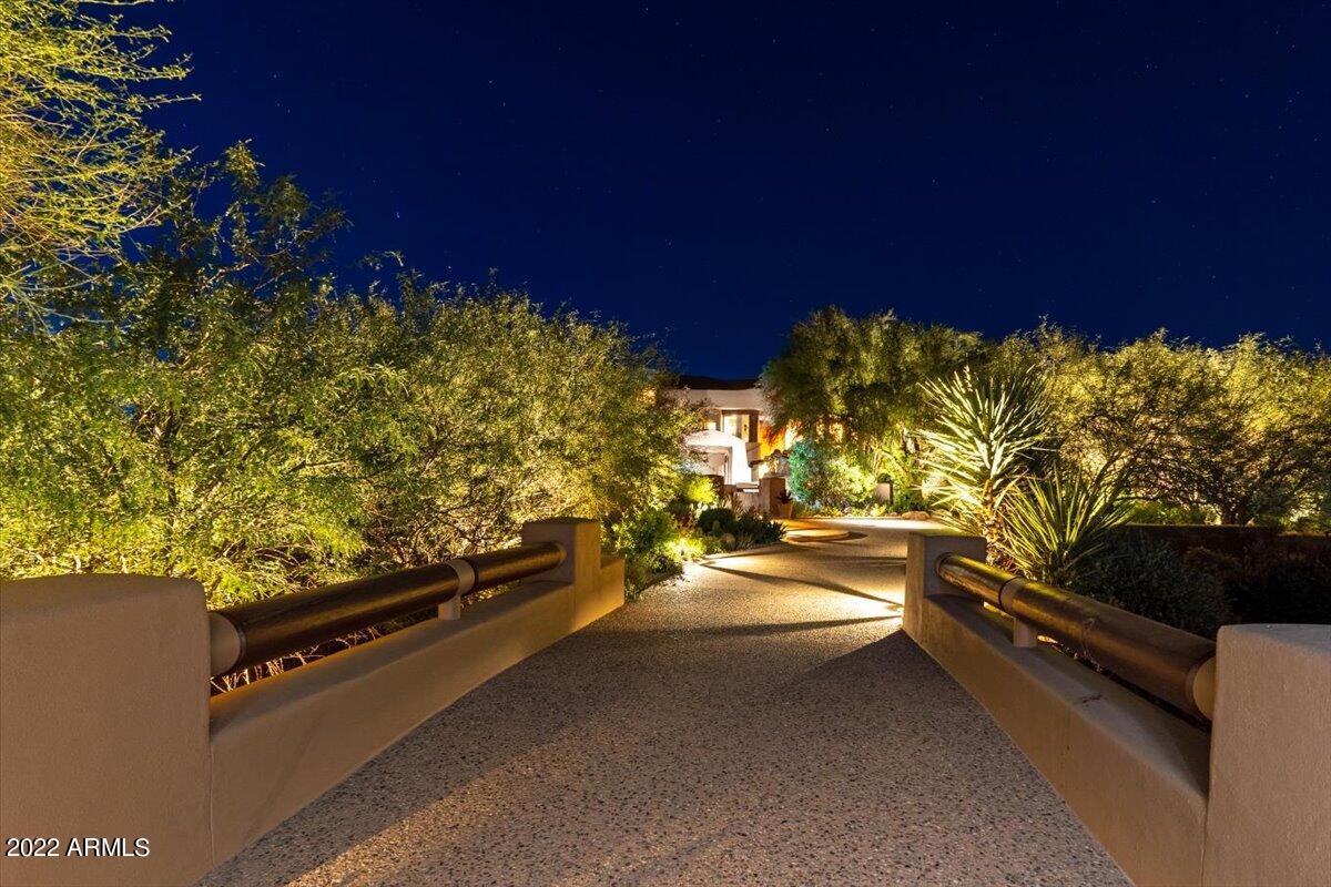 A classic Pueblo-style architectural showpiece overlooking the 3rd fairway of the Renegade golf course at Desert Mountain and evokes the warmth and casual luxury of the West. Well appointed by exquisite custom furniture, southwestern sculptures and art, all highlighting the stunning features of the home. Entering through the hand carved front gate, one is greeted by a tranquil courtyard entry with waterfall and stunning vistas. Inside, the great room is anchored by picture windows featuring sweeping mountain views. Spacious interiors flow to a chef grade kitchen and beyond to multiple patios, all offering stunning views. SEE motion VIDEO; Available Golf Membership. A generous primary suite with intimate fireplace, 2 guest bedrooms plus office loft plus a wine tasting room. Three car garage and an elevator. plenty of room to expand the backyard, pool and bbq settings.   SEE MOTION VIDEO