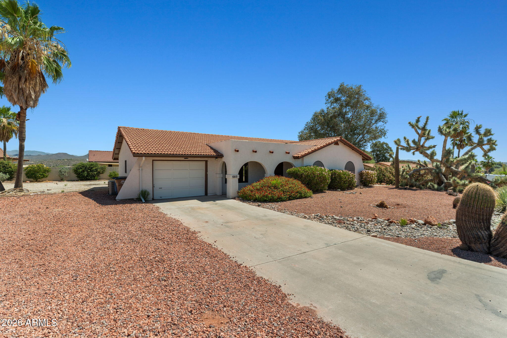 Beautifully maintained home in desirable Mariposa Heights situated on an oversized lot with plenty of room for RV parking and all your toys. Enjoy low-maintenance landscaping with an automatic drip irrigation system and both north- and south-facing patios perfect for taking in Arizona's stunning views and outdoor lifestyle. Inside, the spacious kitchen features abundant storage, a breakfast bar, and easy flow into the dining area with large picture windows. The open living room offers seamless access to the back patio, creating a comfortable space for indoor-outdoor living. The primary suite includes a walk-in closet and private bath with a step-in shower, while the guest bedroom offers a generously sized closet. The garage is equipped with built-in shelving, utility sink, and laundry.
