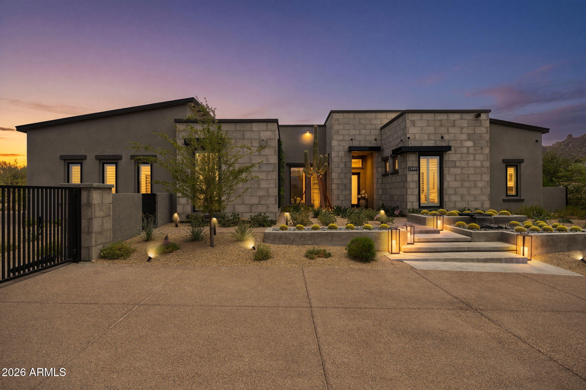 Welcome to one of Sereno Canyon's most exceptional estates. Situated on a rare 1.72-acre homesite, this 2023-built retreat offers over $1M in curated upgrades and a level of privacy seldom found in new construction. Designed for both grand entertaining and everyday luxury, the home features 5 ensuite bedrooms, designer interiors, natural stone finishes, and stunning fireplaces throughout. Step outside to a resort-inspired backyard with a spectacular pool and spa, sunken conversation lounge, expansive lawn, and a chef's outdoor kitchen with never-used Twin Eagles appliances. Mountain views, a gated drive, and seamless indoor-outdoor living create an extraordinary desert sanctuary just minutes from Scottsdale's premier golf, dining, and hiking. Golf lovers and casual players will appreciate that Sereno Canyon residents receive a complimentary Troon Premium Plus card, an exclusive membership which delivers 15% off every round, up to 50% off tee times booked within 78 hours, six guest passes, $150 in shop credits, and Gold Status with points accumulating and usable across most Troon's prestigious portfolio of golf courses and club houses.