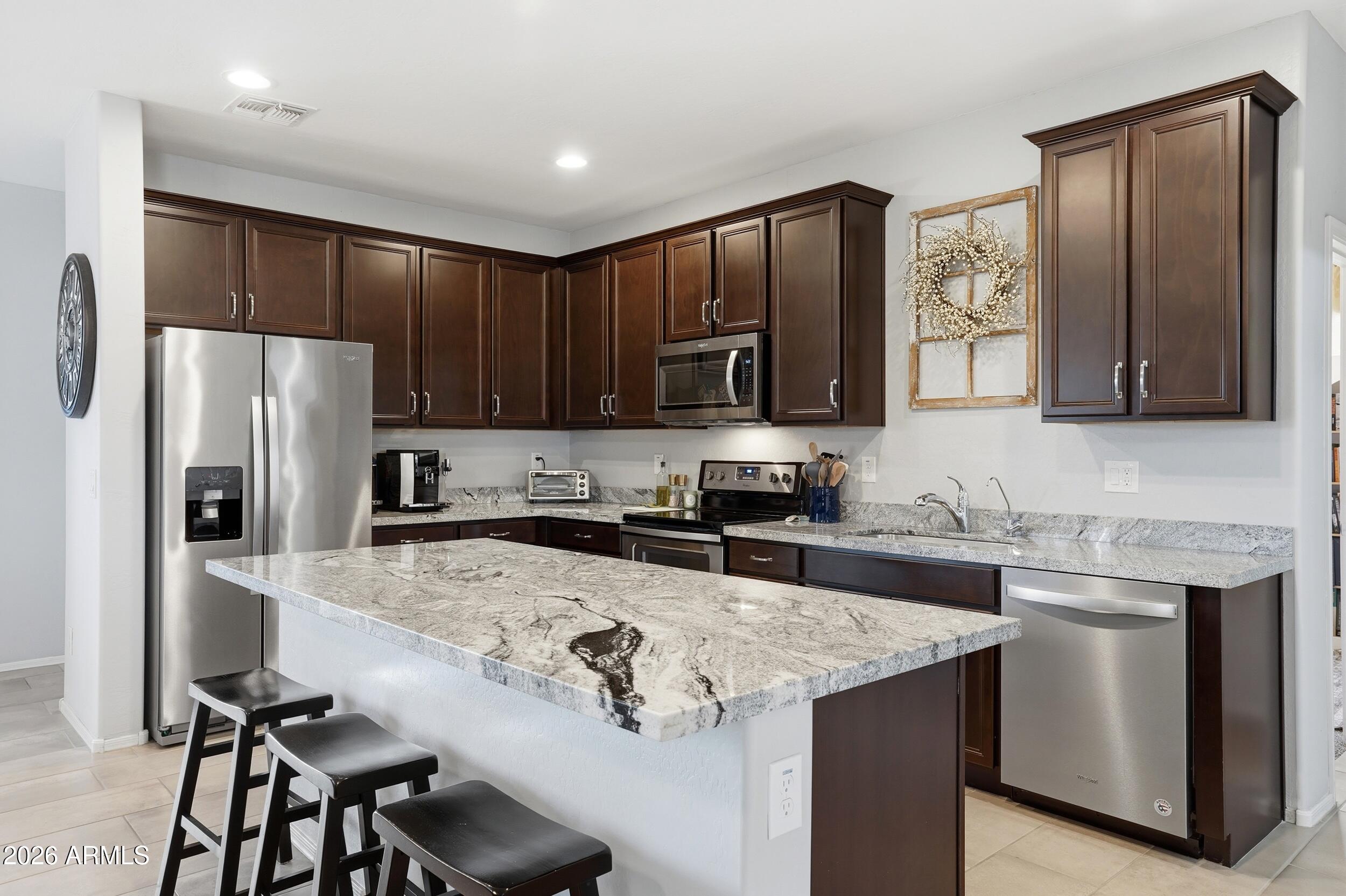 Stunning 2018 Garrett Walker home in a gated community featuring three bedrooms with the option of a fourth!  From an RO system and water softener to the backyard oasis with pavers and artificial turf, this home has it all.  The primary bathroom features a vanity area, remodeled tile shower with soaking tub and large customized walk-in closet.  New water heater in 2025, a security system and security door at the front, and storage racks in the garage... there are no projects left to complete!  Enjoy this open concept home with large kitchen island and beautiful granite countertops.  You'll want to put this home on the top of your list!
