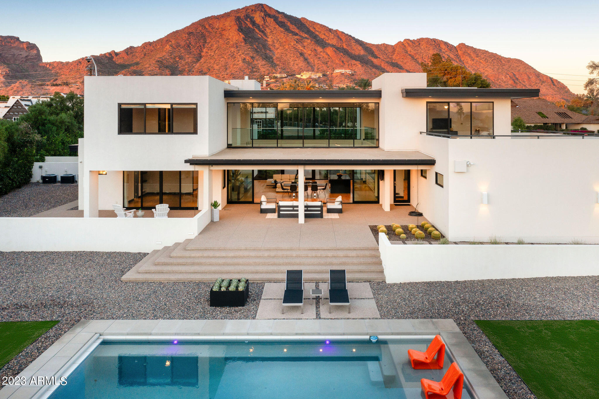 On the hottest corner in Arcadia is a rare Bauhaus-inspired modern by architect David Dick. The epitome of style, luxury, quality and privacy. Enter from Exeter to a grand natural light-filled great room with 20ft ceilings. Gourmet kitchen with a giant island. Two split ensuite bedrooms on 1st floor. Third ensuite on 2nd floor. Catwalk to the main bedroom with an incredible bathroom and giant closet with clerestory view of the iconic profile of Camelback. Morning light-flooded east living room with a patio, large loft upstairs featuring the best views in the house. Full guest quarters AND an office - both with private entrances. Newer heated (and chilled) pool. Extra top-level features - backup gas generator, elevator, automatic gates. Like-new condition t/o. Much more - Check Docs. There is nothing in Phoenix quite like classic Arcadia. Nestled against the majestic backdrop of Camelback Mountain, this scenic neighborhood offers a perfect blend of natural beauty and urban convenience.

Citrus-lined streets harken back to the early grove years of the area, large lots offer privacy, and a mix of architectural styles adds character to the community. Top rated schools and community centers. Unmatched proximity to downtown Phoenix and Old Town Scottsdale offers best food, shopping and entertainment options nearby. 

Experience the warmth of a close-knit community where neighbors become friends and memories are made a short golf cart ride away. Whether you're seeking a family-friendly environment, investment opportunities, or simply a place to call home, Arcadia welcomes you with open arms.

Exeter and Rubicon is today's hot spot for high end development with grandiose mansions being built in every direction.