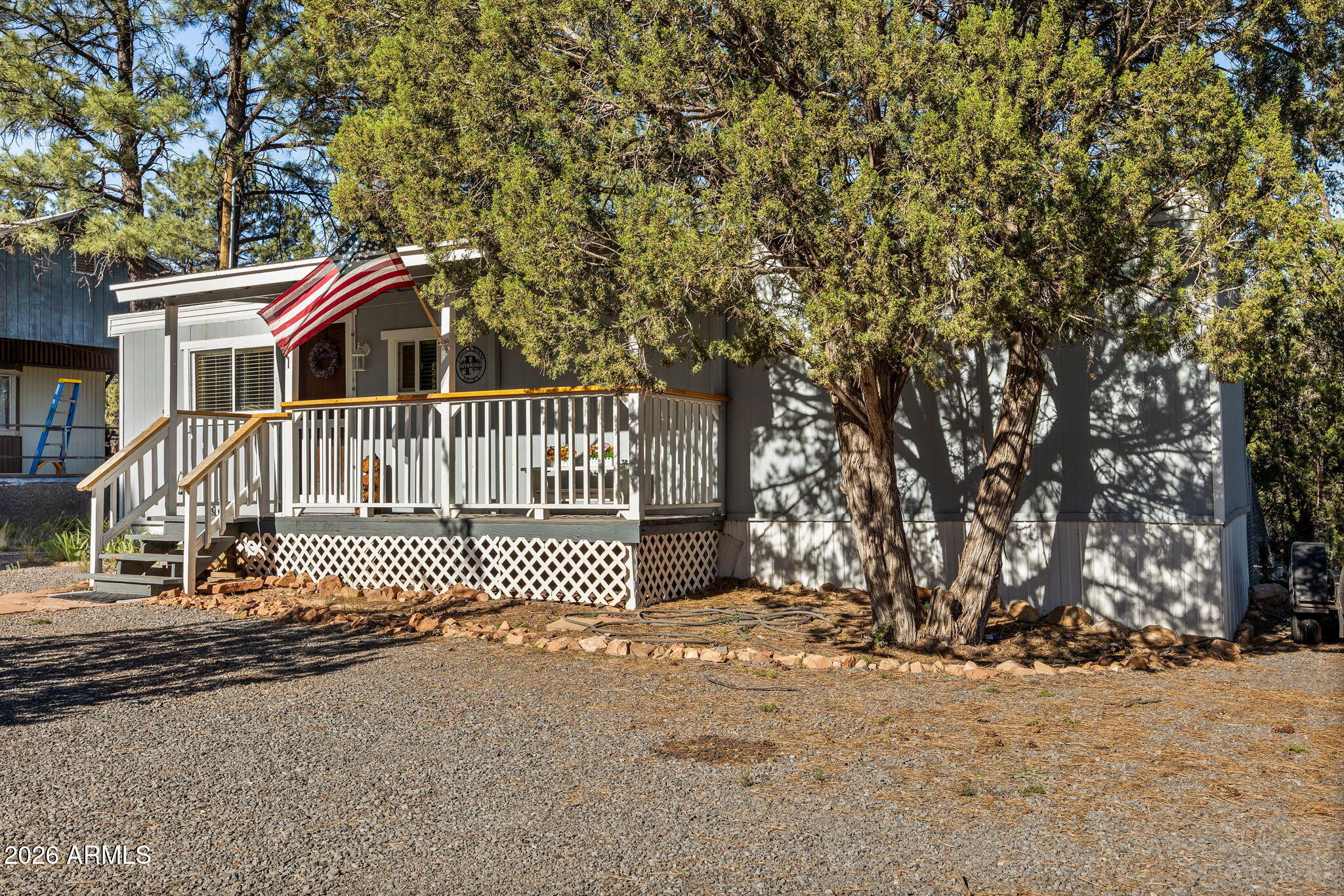 this 1-bedroom, 1-bath singlewide has been thoughtfully remodeled top to bottom for easy, worry-free mountain living. Inside, you'll find a ductless mini-split for heat and A/C, hickory cabinets, a farm sink, a tiled tub/shower, and waterproof vinyl plank flooring throughout. Warm pine ceilings, wainscoting, and pine interior doors give it true cabin character in a compact, low-maintenance footprint. The big-ticket updates are already done: new dual-pane windows, metal roof, PEX plumbing, gas water heater, updated lighting, and a 200-amp meter loop so you can simply move in and enjoy. The refrigerator, gas range, and built-in microwave all convey. Outside, relax on the covered front and rear decks, gather around the firepit, and tuck your gear into the handy storage shed. An affordable basecamp for weekends in the pines or a full-time hideaway. Come take a look and make it yours today.