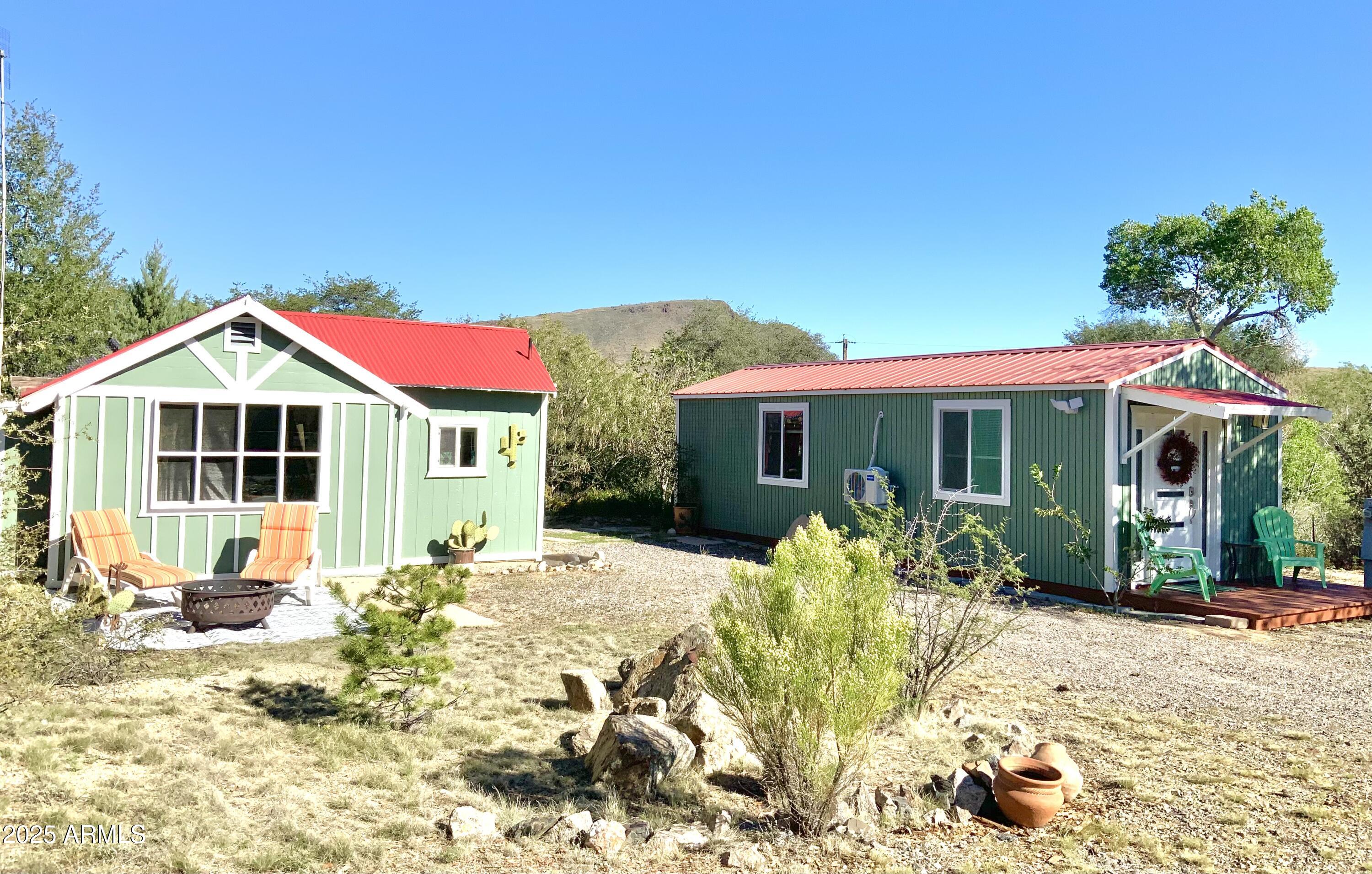 Unique double cottage living in the quaint town of Yarnell. Newly renovated bungalows, each has 1 bedroom, 1 bath. A great set-up for mother-in-law quarters, private office, art studio, or Airbnb rental complete with RV hook-up. Fabulous mountain views from spacious deck w/outdoor bar & solarium. Located on a quiet road with new partial perimeter fencing, entry gate & nice shed behind property. Parcel #203-03-060 is adjacent and available to purchase  (mls #6945877),if you are looking to live close while you build larger home and have future rental income property next door. Septic is in on the vacant lot, Seller would consider reduced price for purchase of both properties.
