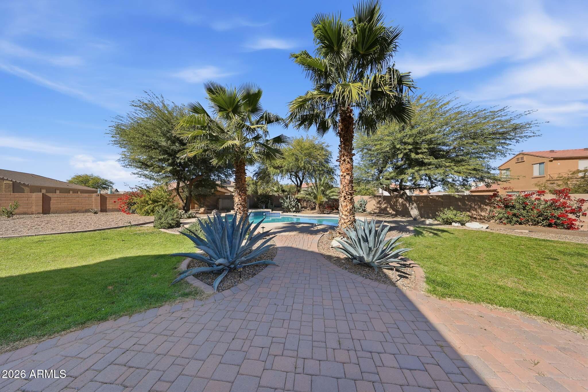 Curb appeal galore! This inviting home is thoughtfully designed for comfortable living and easy entertaining. From the charming front covered patio and courtyard to the expansive, beautifully landscaped backyard with a pool, fire pit, citrus trees, covered and extended patios, recreational track, and kids play area, the outdoor space truly shines. Inside, a well designed floor plan offers formal living and dining rooms, a spacious family room, and an open kitchen with island, gas range, wall oven, built in microwave, and walk in pantry. Upstairs features a loft and bedrooms, including a welcoming primary suite with French door entry, round coffered ceiling, and large walk in closet. Single plus two car garage with built in cabinets provides ample storage and parking.