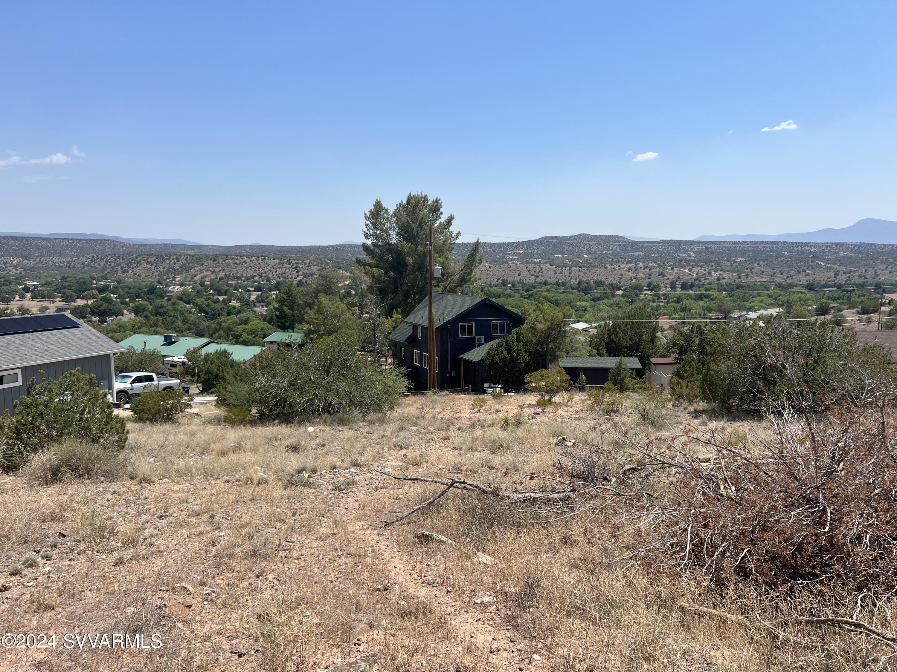 Two combined lots in the Lake Montezuma Hills subdivision, overlooking a lush green belt totaling .38 acres. This parcel is ready to be built on, with water to the lot line, and 1,000 gallon septic already in place. The views are spectacular and included, mountains, creek and trees. Located on a cul-de-sac for very limited traffic. R1L-10 zoning allows for site built homes only. This could be the ideal spot to build your dream home!