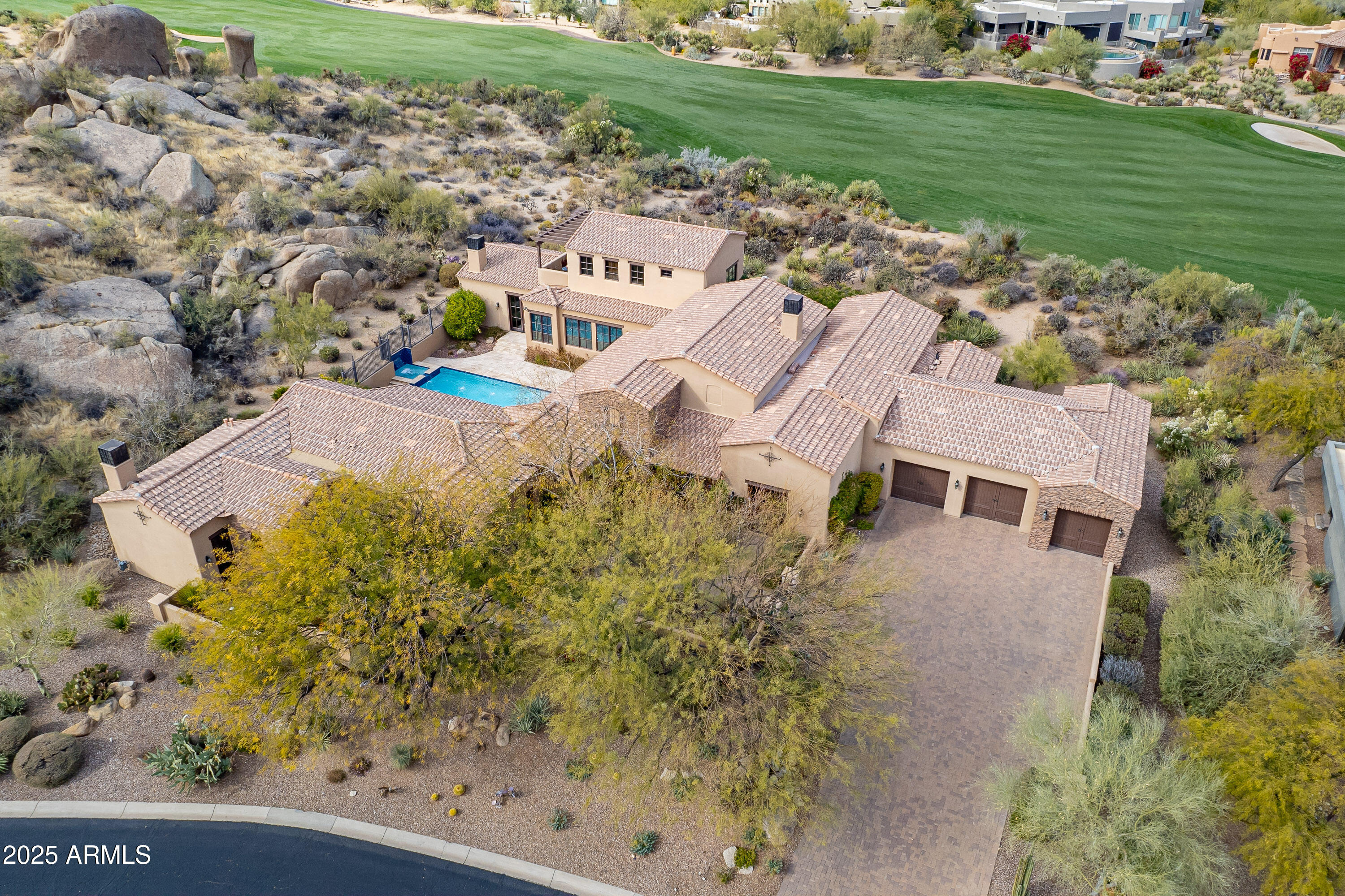 Find the epitome of timeless elegance is  in this European Old-world charm-inspired manor!

Breathtaking elevated views, including the 14th fairway of Troon North's Monument Golf Course, mountains, boulders and desert landscaping.

Natural light, pristine, crisp, fresh and coziness throughout!  

Stone flooring, vaulted ceilings with wood beams, French doors, arched windows, private courtyard, resort-like pool amenities, firepit, built-in BBQ, oversized center island with a breakfast bar that seats six, Cantera fireplace, floor-to-ceiling showers, walk-in closets, putting green, walk-in pantry, a Casita with a separate entrance, tandem garage, custom details and so much more.

Televisions, window coverings, putters, stereo equipment, pool fence, and various items convey.
