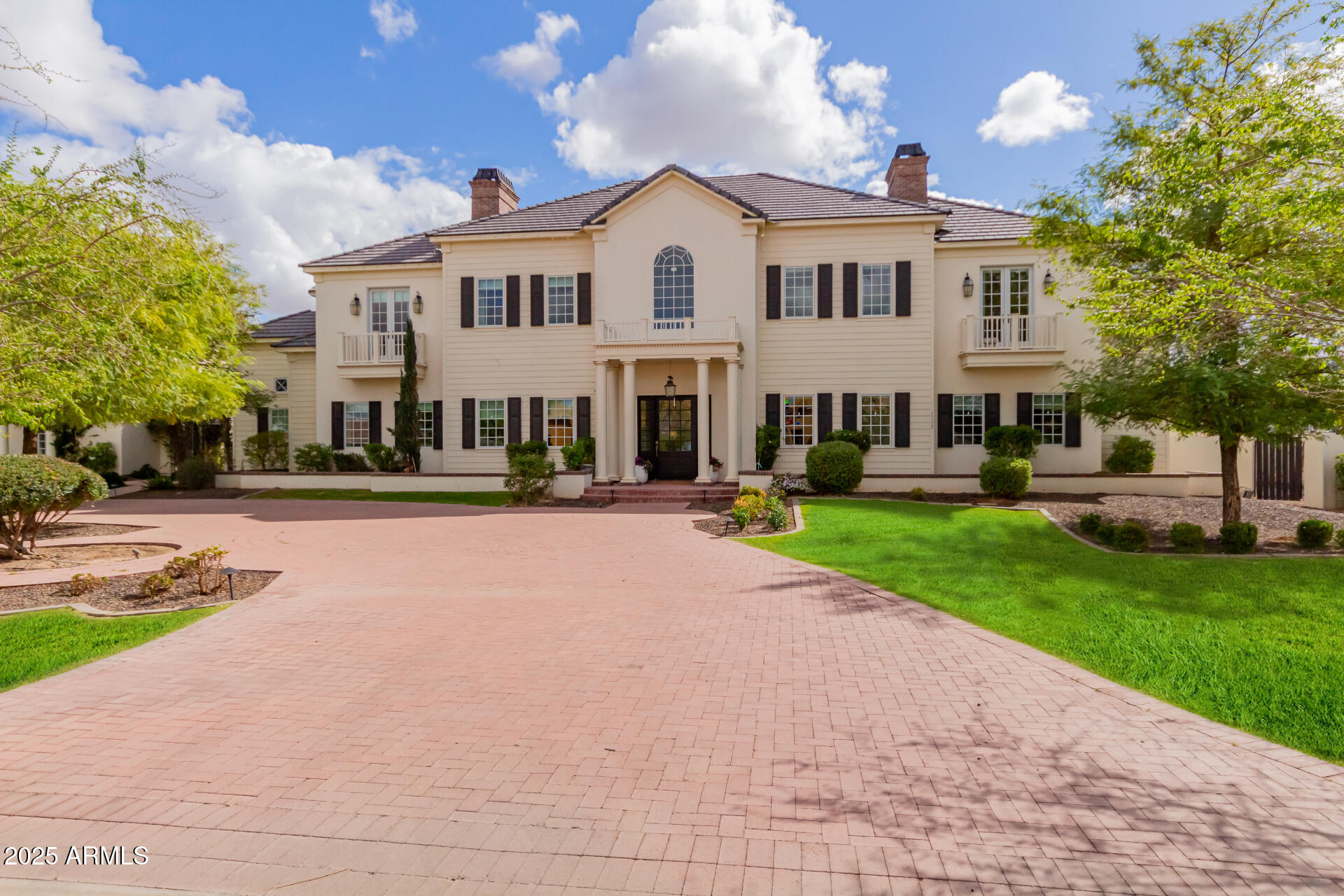 Welcome home to this luxury Temple View Estates home featuring 6 bed 6.5 bath + guest quarters and a dream yard on an acre! Professionally designed by interior designer Becki Owens, the home features a gorgeous entry, timeless engineered hardwood flooring, high-end wooden grid Pella windows, 3 cozy fireplaces, and custom cabinetry throughout! The kitchen is a dream with a French LaCanche range, marble countertops, a hidden walk-in pantry, and a beautiful dining nook with a view of the sparkling pool + hot tub! The master has a vaulted beam ceiling with the bathroom and closet of your dreams! The timeless exterior has a circular brick driveway, a nice courtyard, a 3+ car garage w/ a separate air-conditioned gym, and an RV gate + parking. This home is sure to enhance your life in every way! All secondary rooms are spacious with walk-in closets and en-suite bathrooms. The mudroom is attached to the garage and features cabinetry-style lockers and a custom tiled dog bath! The laundry room features double stacked cabinetry for lots of storage and double sets of washers and dryers to lighten your load! The upstairs playroom has built-in bunk beds and beautiful built-in storage. Don't forget the additional bonus den upstairs - perfect for each group to have their own space during gatherings! Wind down the nights under the pool house or at the outdoor firepit. The options are truly endless with this home in a highly sought after Gilbert neighborhood- it's sure to go quick!