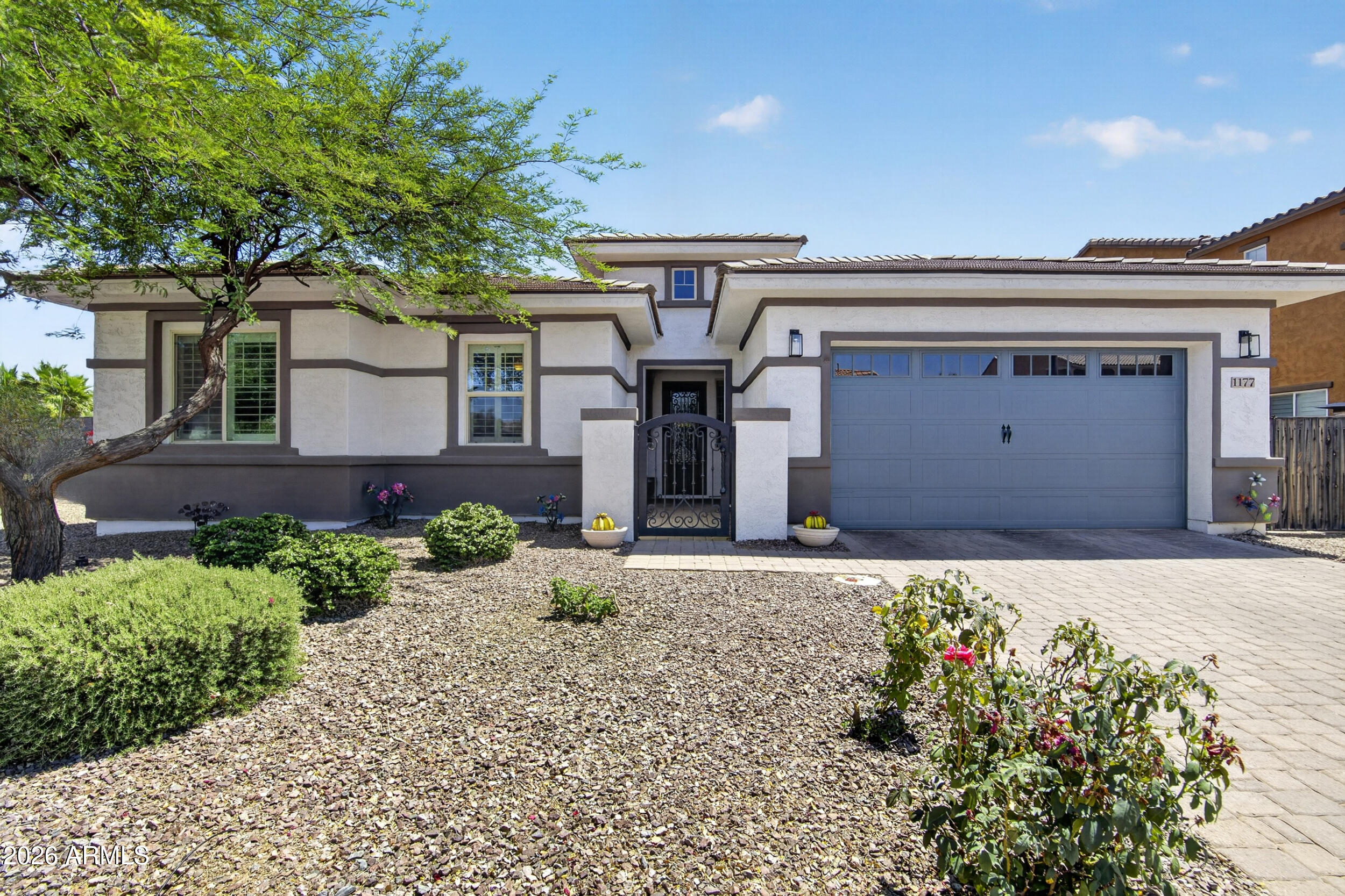 Amazing 3 bed 3.5 bath single level home with office that has been completely updated. Enter through a custom front door to a foyer with beautiful tile floors and high ceilings leading to the open-format living area and updated kitchen. Formal dining room with custom built in cabinets. New carpet in bedrooms, central vacuum, and shutters in every room. The primary bedroom has an updated bathroom, closet storage with shelving that everyone can appreciate.  There is a four car tandem garage with A/C, built in cabinets, 220v car charger, epoxy floor, overhead pulley storage, and surround sound. Speaking of entertaining by the pool, just wait until you see this backyard! The enormous covered patio with canned lighting illuminates one of the most beautiful built-in kitchen islands you could dream to cook in. Work and play, or relax in the resort-quality pool with swim-up seating, waterfalls and spa. Not to mention a fully air-conditioned additional unit completed with a half bath that can be used as a pool-house, a home office, a changing room, a craft room, a play-house - the possibilities are endless!