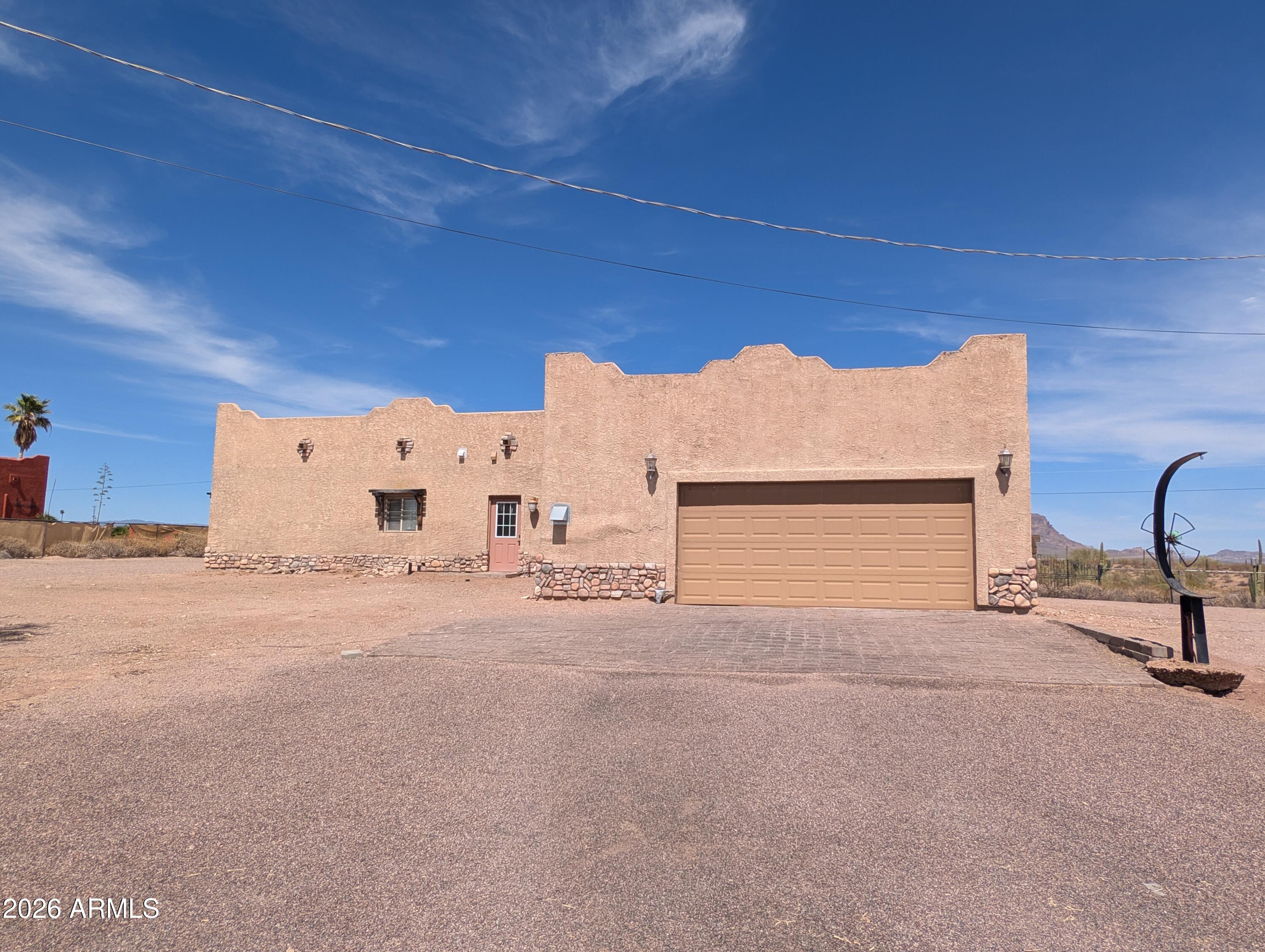 One of a kind home on .74 acre lot with stunning views of the Superstition Mountains!  Access to state land for trail riding across the street with horse boarding nearby.  Generous yard with beautiful fountain, pergola, and unique carved fence posts with rustic iron work around the property.  There is an outdoor shower with access to the primary bedroom from a door featuring stained glass. 
Inside you will have an updated kitchen with stainless steel Kitchen Aid appliances featuring a Frigidaire induction cook top.  The primary bedroom with en-suite features custom details with a secret room hidden behind a book case and a separate mini-split AC unit.  The main AC unit was updated in 2023, new water heater in 2025. Many custom details throughout. There is some stucco work needed so property will not qualify for FHA.  So many great details about this property, too many list!