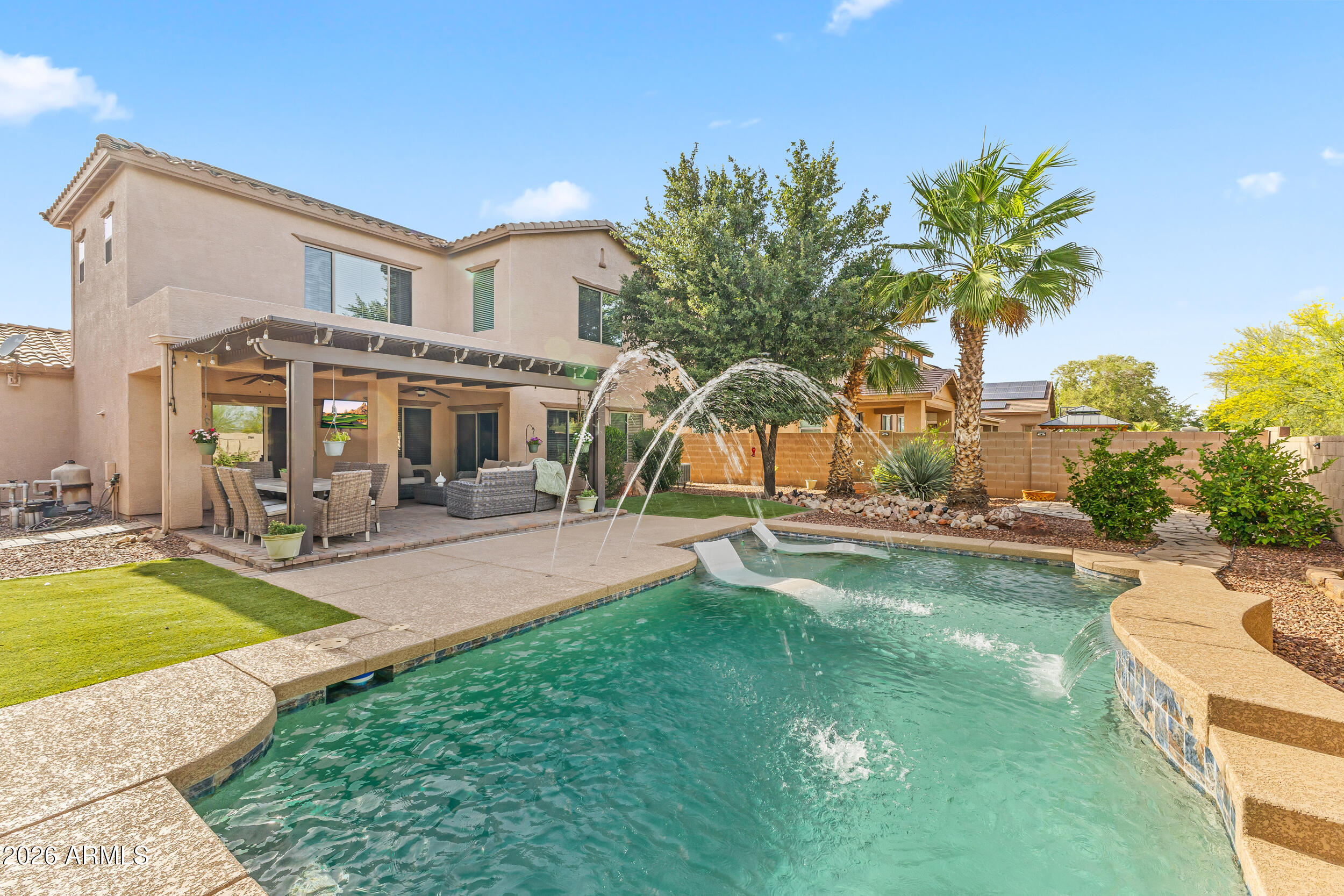 Resort living in this stunning 2-story 2810sqft home with a refreshing pool nestled on an oversized lot located in the growing community of Asante!
2 spacious primary suites with full bathrooms and walk in closets, 2 addtl bedrooms have an adjoining bathroom with separate vanities, luxury vinyl flooring, granite countertops, SS appliances, maple cabinets, flexible floor plan with multiple living/dining areas, extended garage with built in cabinets, epoxy flooring, extra pavers on driveway for addtl parking and solar panels. Dream backyard includes a sparkling pool with baja seating/water features, pavers, artificial grass, covered patio and gazebo for relaxing/entertaining, mature trees for privacy and no behind neighbors. Close proximity to parks, shops, dining and schools. It's a BEAUTY
