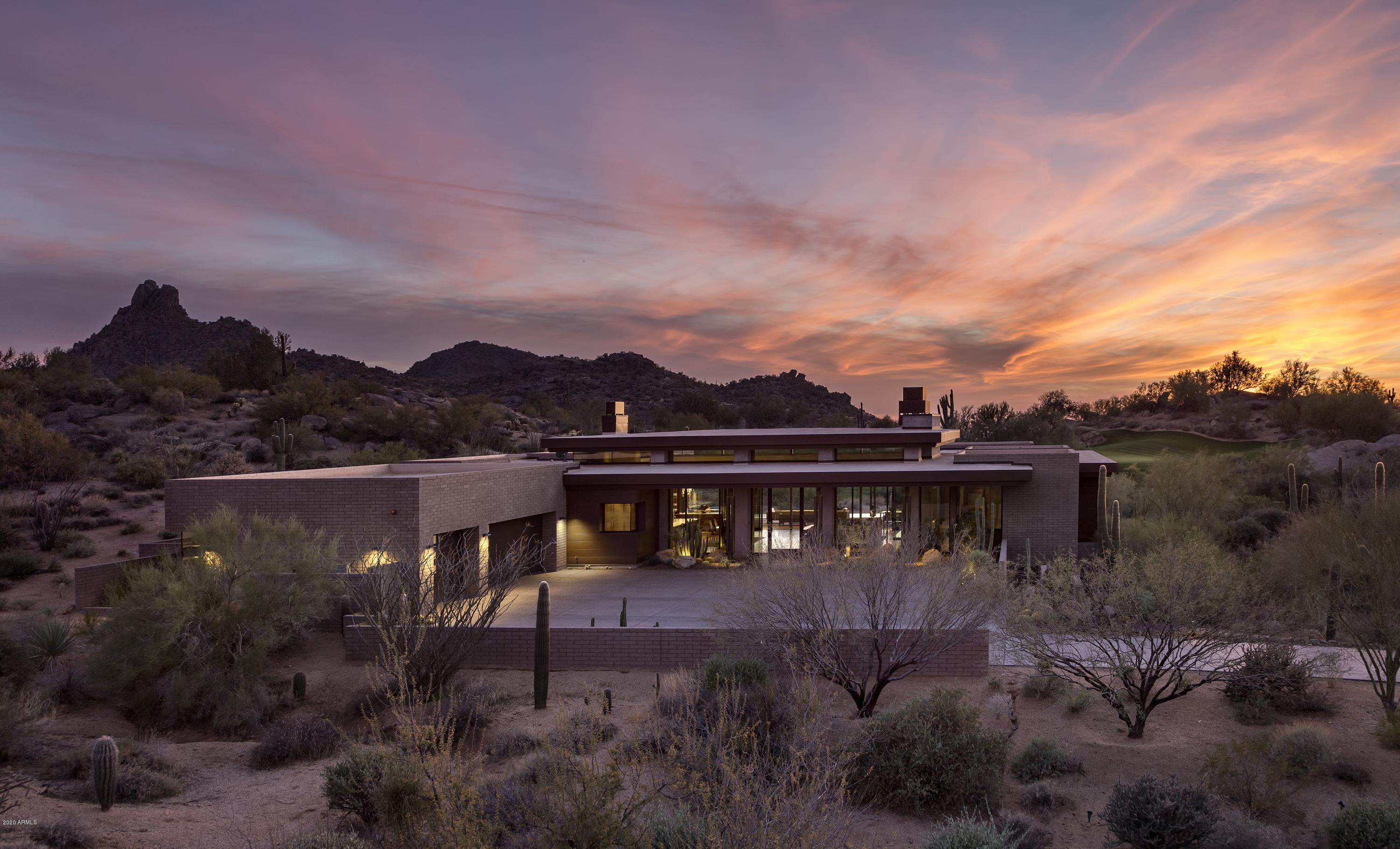 Chic modern design sited on the 17th hole of The Estancia Club with golf course, sunset and Pinnacle Peak views * Designed by Tate studios the exterior elements offer a unique architectural blend of poured-in-place concrete, glass, steel and stacked block * Ideal great room floor plan with soaring ceilings, zero interior steps and the master suite split from 3 guest ensuites * Interior details include exposed block walls and concrete columns softened by natural quartzite counters, reclaimed white oak flooring and Makassar ebony cabinets * The dominant feature of the home is the oversized great room with a massive concrete structure framing the linear fireplace * The great room flows seamlessly to the outdoor living room through motorized glass doors * Outdoor living area features a heated pool/spa, deep covered patio, gas firepit and built-in BBQ station * A 3-car garage completes the residence *