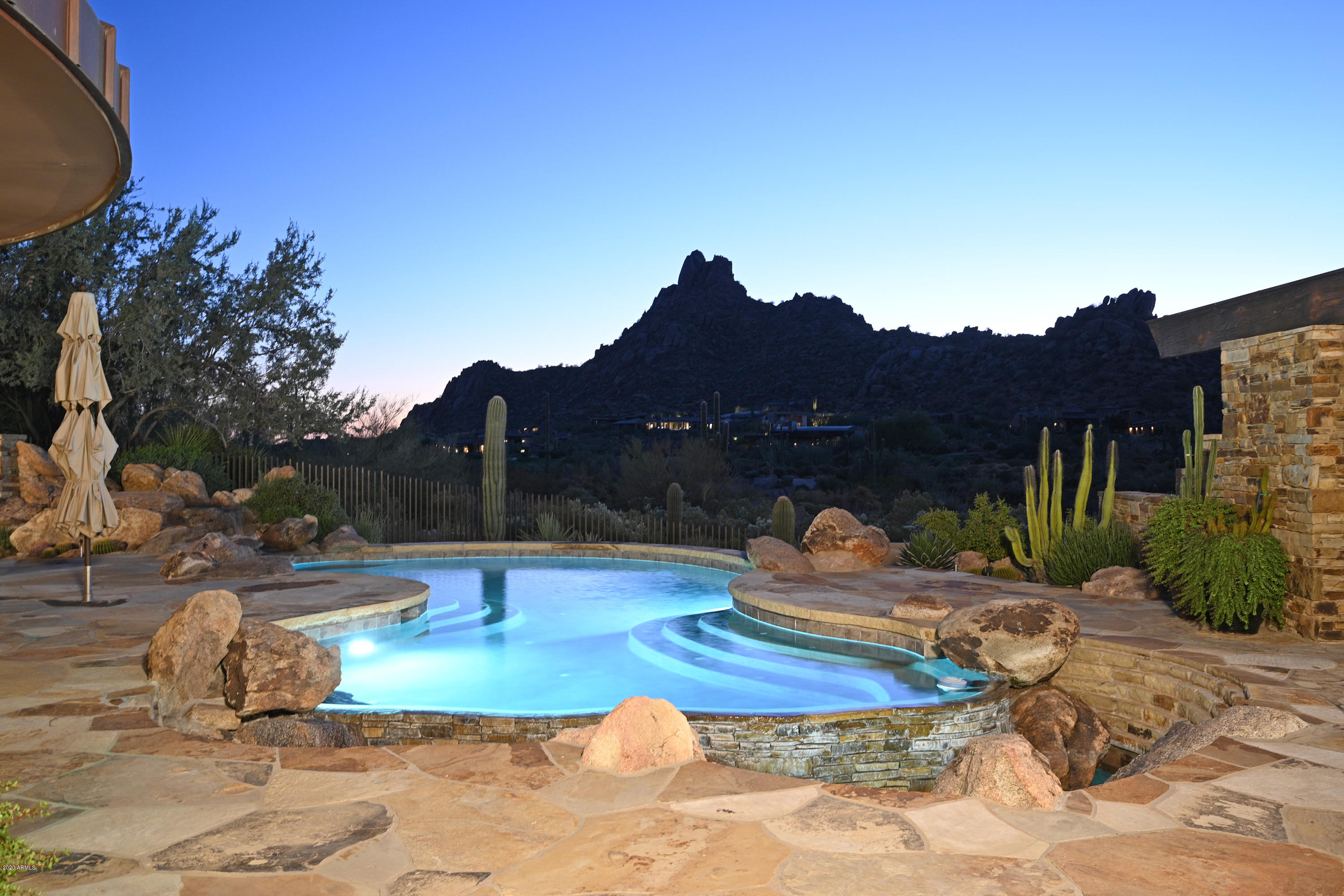 SIMPLY STUNNING!  On one of BEST lots in Estancia with unobstructed VIEWS of PINNACLE  PEAK & the GOLF COURSE, this custom designed home by James Hann is a stand out! The floorplan consists of a spacious GREAT rm, formal dining, a breakfast rm off the kitchen, a split master suite w/a sitting area & a study w/an ensuite bathroom that could be an EZ conversion to a 4th bedroom.  This gorgeous CHEF'S kitchen has a 6 burner VIKING gas cooktop, DACOR double ovens & built-in microwave, & a Sub-zero refrigerator & wine cooler. There is a sep. GUEST CASITA, complete w/a sitting rm, bedroom, bathroom, walk-in closet & separate washer/dryer. The RESORT style backyard boasts a sparkling pool, heated spa, built-in BBQ, gas firepit & BREATHTAKING mountain VIEWS all around. Main house 4,489sf, GH 600sf