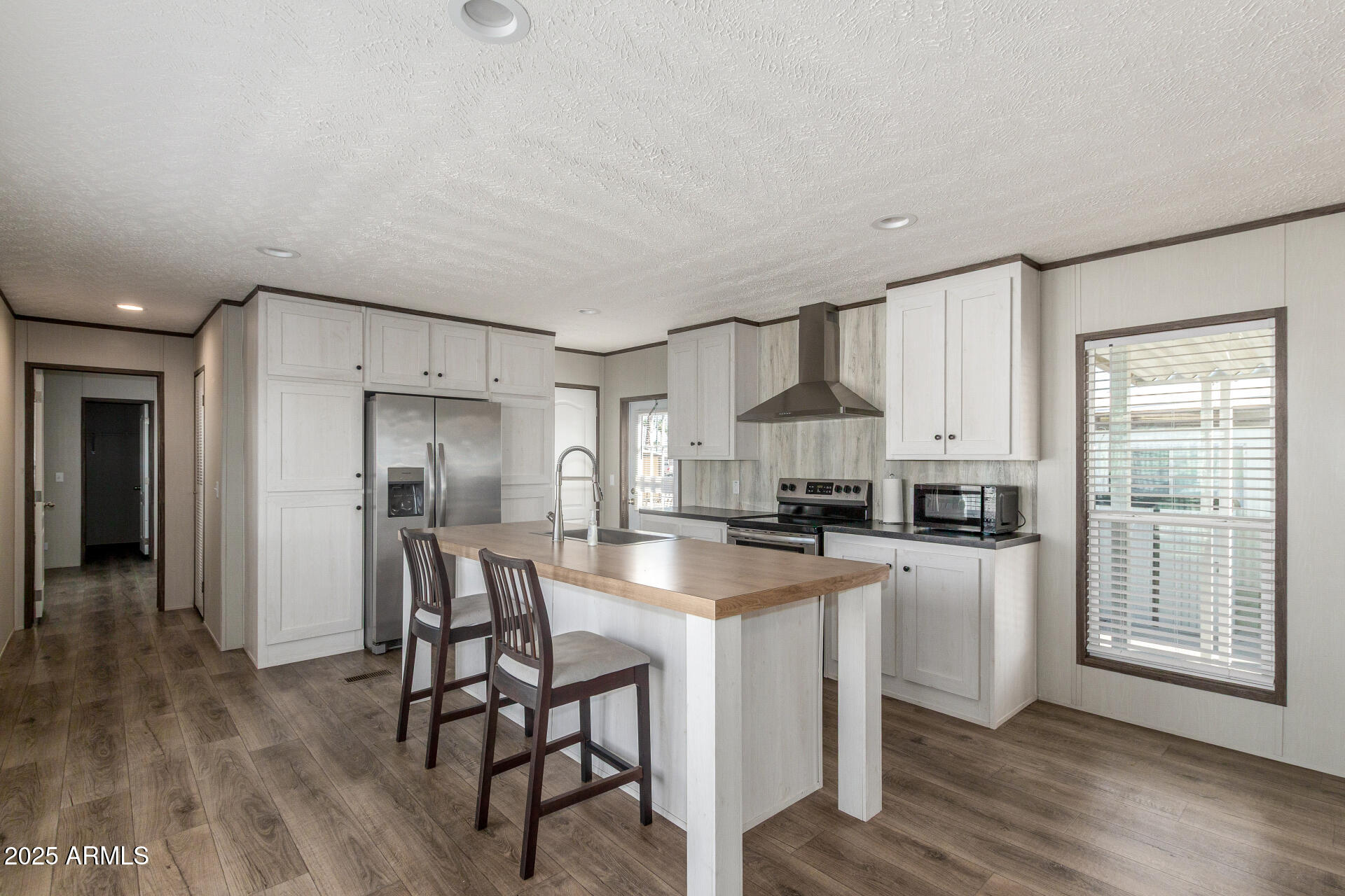 Welcome to this charming, well-maintained manufactured home in Vista Del Sol! This beautifully crafted residence by Schult Waco 1 offers 2 beds, 2 baths, & 1020 sqft of thoughtfully designed living space. The inviting interior showcases tons of natural light, neutral palette, and wood-look tile flooring t/out. Enjoy a modern open-concept layout with a media center! The spacious kitchen boasts SS appliances, white shaker cabinetry, recessed lighting, and an island w/breakfast bar. The cozy main suite has a walk-in closet and a full bathroom w/dual sinks. The carport parking can be your relaxing area as well! With its Resolution 16682X model, this home balances function and style, making it an excellent choice for those seeking a comfortable and affordable living environment. Move-in ready!