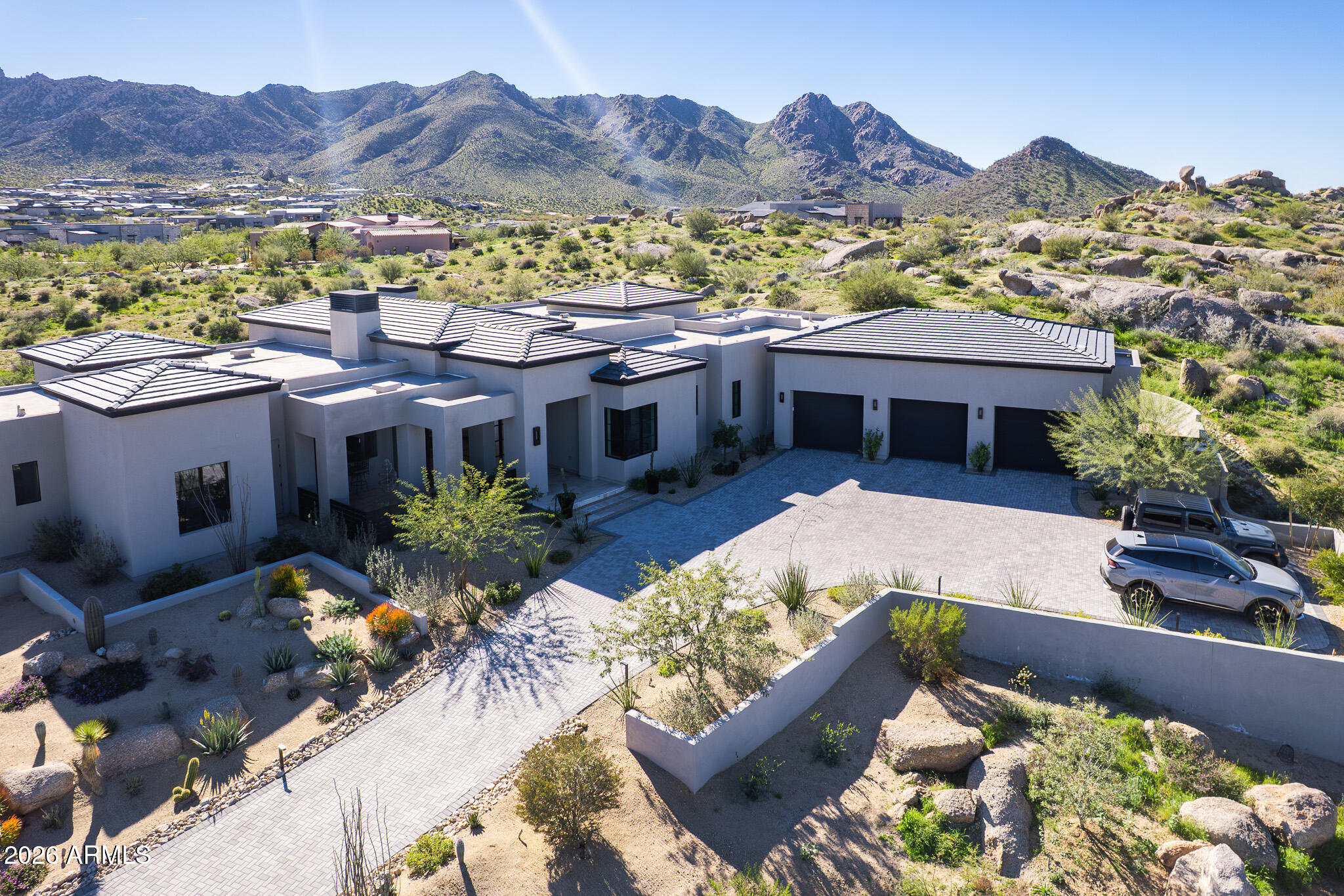 Welcome to this exquisite luxury custom home designed and built by Luxor Homes, depicting the ultimate in character and design on 1.6 acre gently sloping hillside lot in the posh gated community of Sereno Canyon - Estate Collection.  Offering 360 degrees of breathtaking views, an open and flowing split floor plan blends the indoor and resort-like outdoor areas to accommodate activities and entertainment galore. The kitchen is outfitted with Wolf/Sub-Zero commercial sized side by side refrigerator/freezer, 6 burner gas range with pot filler, custom designed VentaHood, separate warming drawer, an island with generous preparation space, solid basalt stone sink, breakfast bar, wine storage, and a walk-in pantry. Bountiful cabinetry and retractable glass doors with mechanical shades enhance the thoughtfully planned layout. The large master suite and a luxuriously appointed resort style bath with exterior access to an outdoor shower create an ideal and relaxing area to retreat to at the end of the day. All bedrooms are ensuite with walk-in closets. Guest bedroom 2 has exterior patio/pool access. Designed with a south facing yard that is easily enjoyed year-round, the 1,051 sf covered patio boasts stone flooring and an open style 2-way fireplace, and a Hestan Aspire built-in BBQ island with rotisserie. The wet edge salt water pool and submerged spa delight. An underground pool vault houses all pool, lighting, and irrigation equipment. Ample parking and storage in the 1,728 sf four car garage with three additional spaces for vehicles outside.
With two 24/7 staffed gated entrances this amenity-rich community boasts spectacular views of Tom's Thumb, Four Peaks and the McDowell Mountains. Minutes away from the trailheads. The Mountain House Lodge boasts a state-of-the-art gym, two resort-style heated pools, tranquil spa services and fitness studio with state-of-the-art equipment to make wellness a part of your daily routine. Dine at Alterra, a fusion of traditional American and international cooking techniques thoughtfully crafted from locally sourced ingredients. Paired with a full-service bar, you can dine with a view from the Four Peaks Patio or enjoy an intimate indoor dining experience with free valet service. A community social calendar with upcoming activities is sent out monthly.
The whirly gig wind spinners (1 in front courtyard, 5 in rear yard) do not convey.
(If you want a true turn-key property, furnishings are available on a separate bill of sale).