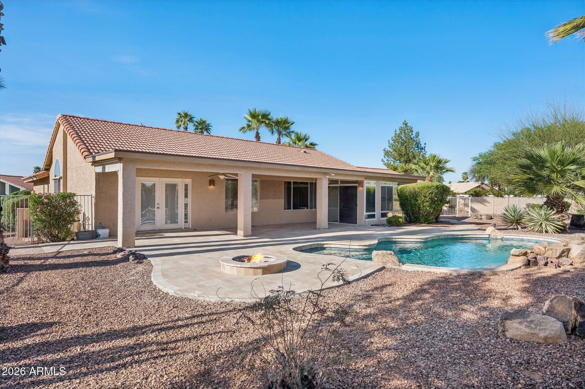 HUGE Price Reduction!  Motivated Sellers! Welcome to this beautifully maintained and upgraded home in the highly desirable active adult community of Sun Lakes. Situated on an expansive 0.39-acre lot, the backyard is a private retreat featuring a PebbleTec pool newly updated with travertine surround and patio, and a gas fire pit. Inside, enjoy a modern updated kitchen, newer flooring, and remodeled bathrooms. A versatile office or 3rd bedroom connects to a bright Arizona room for added living space. Major upgrades include a new roof (2025) and HVAC (2023). Residents enjoy access to golf, tennis, pickleball, pools, fitness centers, restaurants, and numerous clubs and social activities.