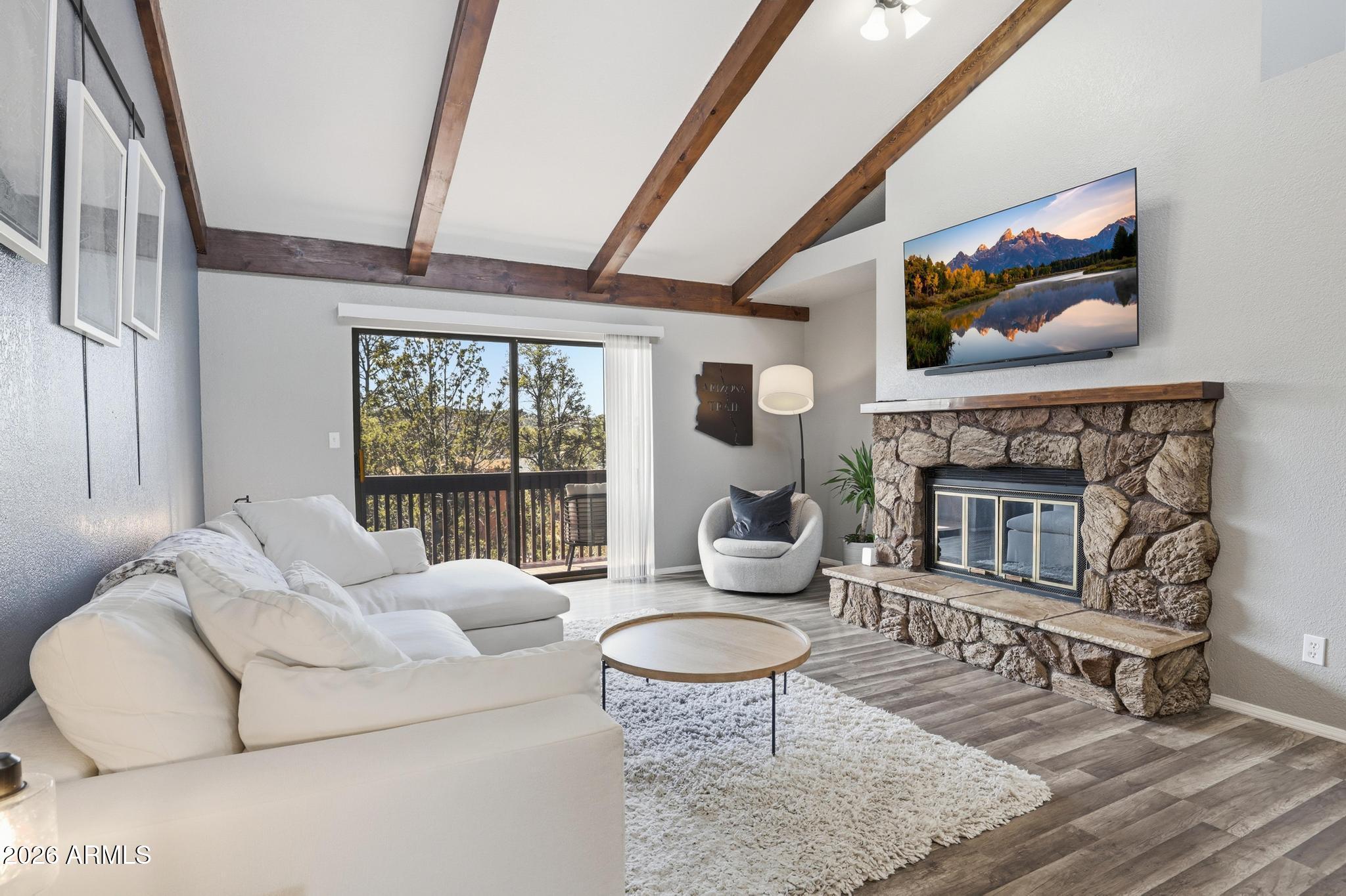 Trade the noise for towering pines, cool mountain air, and the relaxed lifestyle that makes Payson one of Arizona's favorite getaway destinations. This fully updated condo offers the perfect blend of comfort, convenience, and retreat-style living for both full-time residents and second-home buyers. Inside, soaring vaulted beamed ceilings and a light-filled layout create a warm mountain feel. The spacious living room features a wood-burning fireplace, perfect for cozy evenings year-round. Newer flooring, fixtures, lighting, updated bathrooms, modern kitchen cabinetry, and countertops give the home a fresh, move-in-ready finish throughout. Enjoy two large walkout decks, one off the living area and another shared by the primary suite and dining room, ideal for personal time or entertaining guests. The 1.5-car garage includes an attached bonus room perfect for a home office, studio, hobby room, or extra storage. Located near shopping, restaurants, hiking trails, lakes, and outdoor recreation, this is your opportunity to enjoy the best of Payson living before someone else does.