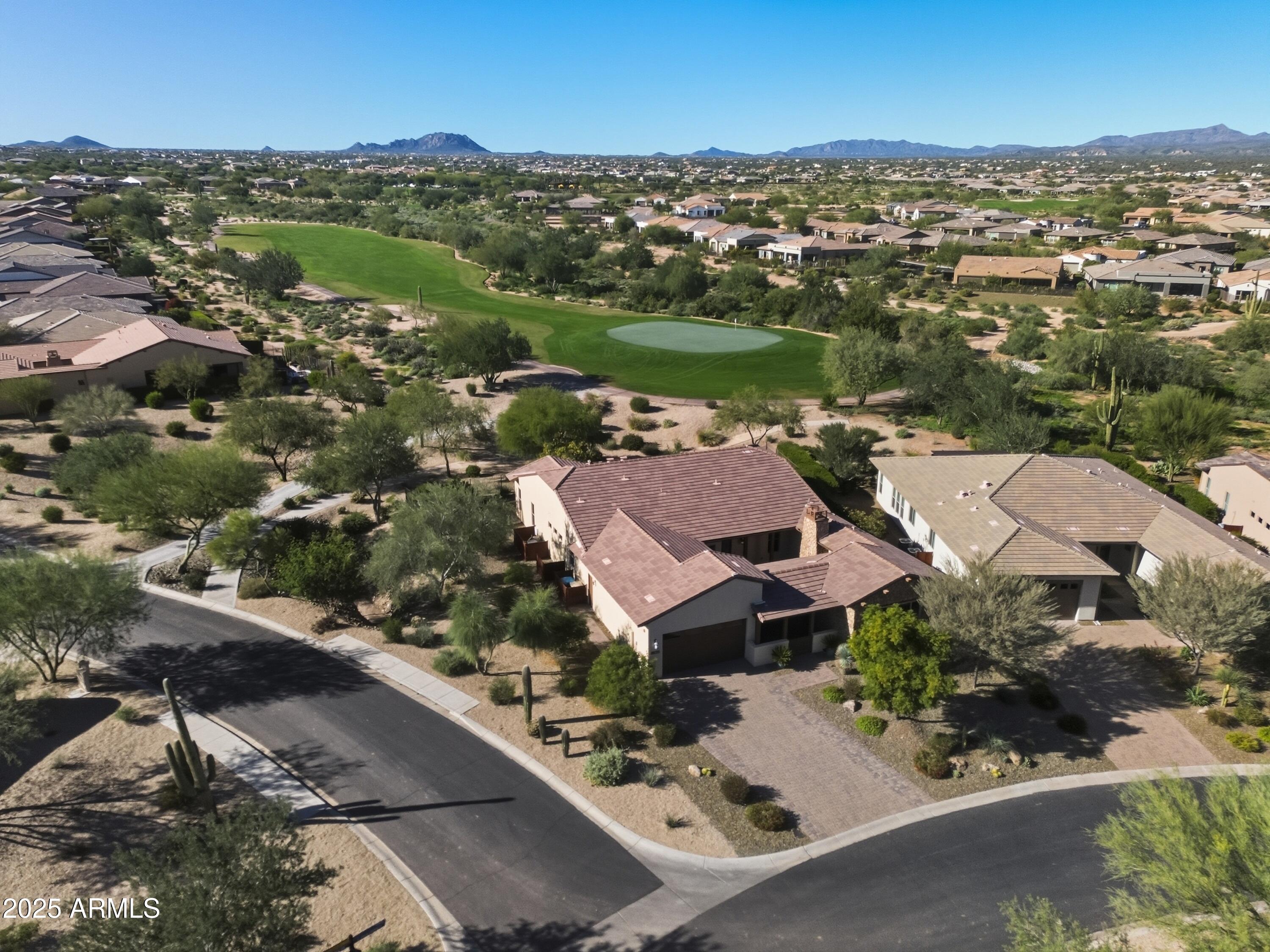 What a find! Highly sought-after Latigo model with Casita option on an oversized, quiet corner golf-course lot in the premier Trilogy at Verde River community—where world-class amenities meet breathtaking mountain and desert views! Nearly $150,000 in recent upgrades from the current owner elevate this home far above the rest, including new wood flooring, designer light fixtures, upgraded sound system with in-ceiling speakers, and Control4 automation for electronics, security, and lighting. Additional enhancements include new motorized shades, a soft-water system, whole-house water filtration, and a brand-new hot tub (2025). The home offers exceptional indoor/outdoor living, starting with a private front courtyard featuring its own outdoor fireplace. The attached casita sits just across the courtyardideal for guests, multigenerational living, or a private office retreat. Inside the main residence, the open split-floor plan delivers natural light and seamless flow. The front guest ensuite provides privacy, while the central living area impresses with a beautiful upgraded kitchen and a wide-open great room perfect for entertaining. The luxurious primary suite features a spacious bedroom, soaking tub, oversized tiled walk-in shower, and dual vanities. A large laundry room offers abundant cabinetry and storage. The 3-car tandem garage adds extra flexibility. Step outside to your private oasis: a sparkling pool and in-ground spa overlooking low-maintenance landscaping and stunning golf-course views. This home blends luxury, comfort, and premier resort-style livinga rare opportunity in Trilogy at Verde River.