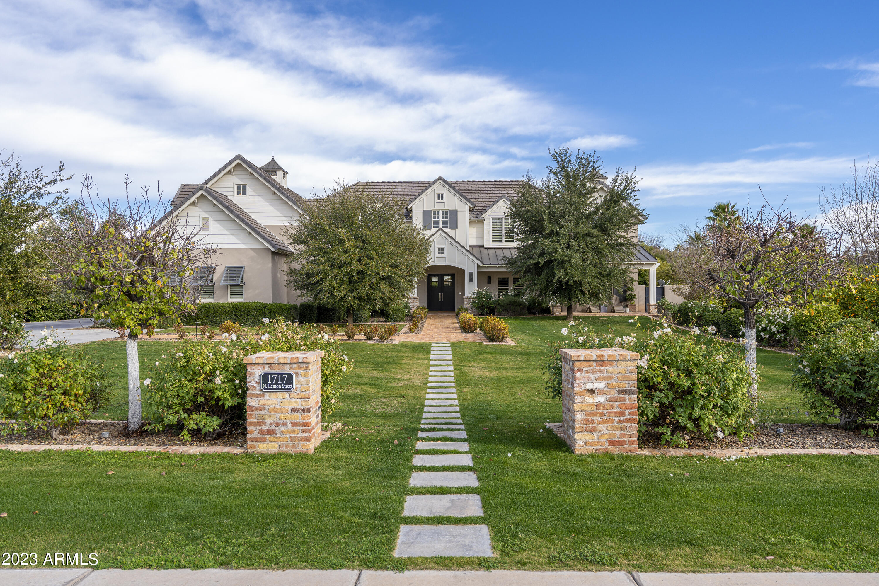 Located in the heart of Mesa's iconic citrus corridor, this traditional stunner rolls out the red carpet for every guest, in the form of reclaimed brick from an old Chicago building leading you to the front door.  Housing over 8,000 square feet of perfectly proportioned livable space, it is an entertainer's dream.  

Built in 2012, this home has stood the test of time with European white oak floors and custom built inset cabinetry throughout.  The kitchen features a wall of windows, that open to the backyard for easy pass through serving, while bathing the home in Arizona sunshine.  Loaded with convenience, the home boasts Subzero refrigerators, Wolf stove and Thermador ovens and dual dishwashers.  Plenty of space to spread out with large guest quarters, spacious pool and hot tub. pebble ice machine, spacious prep pantry and a drop zone off the 5-car garage that has room for a boat.

Today's market allows you the rare opportunity to buy custom for less than you can build it.

The spacious living room features a focal point fireplace, which is mirrored on the back patio along with soaring tongue and groove ceilings that greet you as you enter.

Just off the kitchen you'll enjoy a secondary family room built for fun with durable floors and a glass wall that disappears for that indoor outdoor living that we all love so much in our beautiful Arizona weather.

You'll find vintage, antique and custom made lighting throughout the home, creating a truly custom, one-of-a-kind home.  No detail has been left undone, with solid wood-core doors, coffered ceilings, dutch doors, dual dish washers, 3 ovens, prep pantry and so much more.

Upstairs you'll find 4 secondary bedrooms with features like window seats, reading lofts and jack-and-jill bathrooms.  Hidden rooms delight and give ample room for play.

The main level of the home features the primary suite with spa like bathroom and private laundry inside the walk-in closet. Guests also enjoy their own quarters on the main level with attached bathroom and laundry.  

Outside you'll enjoy sport court, heated resort style pool with hot tub and a separate pool house that is used as a private gym. Home is also equipped with a generator that is capable of powering the home.

Upstairs delight in secondary bedrooms with attached bathrooms, hidden play rooms and the main laundry room.

Cobblestone at The Groves offers a desirable location, with easy access to major freeways, shopping, dining and entertainment. The community is also served by the top-rated Mesa schools. This is a rare opportunity to own a piece of paradise in one of Mesa's most exclusive and sought-after neighborhoods.