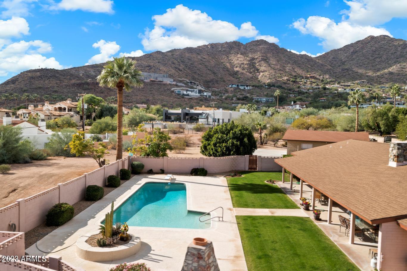 Exciting opportunity in Paradise Valley, Explore this mid-century modern gem in an unbeatable location, offering breathtaking views!  Discover timeless allure on Sage Drive, Paradise Valley's iconic address. This quintessential Arizona charm home sits on a 1.24-acre flat, rectangular lot, offering alluring views in every direction, with an up-close perspective of Camelback Mountain. Embrace the potential to live in its classic charm, remodel to suit your style, or craft your dream home. The canvas is yours to create, surrounded by the beauty of Paradise Valley.