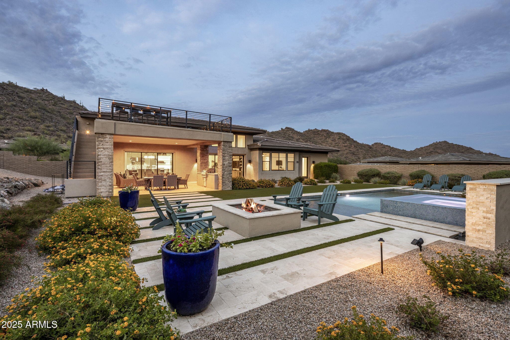Experience elevated desert living in the prestigious gated community of Adero Canyon with this stunning 3,413 sqft Toll Brothers Parker model, offering 3 bedrooms, 3.5 baths and a versatile den. Designed for both refined entertaining and everyday comfort, this residence blends sophisticated finishes with thoughtful functionality at every turn.  Step inside to soaring ceilings with rich tongue-and-groove wood accents in the open-concept family room and kitchen, where Wolf and Sub-Zero appliances, custom cabinetry, granite and quartz surfaces, and a spacious butler's pantry set the stage for gourmet excellence. The oversized kitchen island invites gathering, while built-in shelving and media features in both the family and game rooms provide stylish spaces for relaxation and entertainment. Tile plankflooring flows through the main living spaces, complemented by plush carpet in the bedrooms for added comfort. The primary suite is a private retreat with an oversized walk-in closet, spa-inspired bath, and direct access to serene outdoor living.  Step outside to a true entertainer's paradisetravertine decking surrounds a sparkling pool and spa, with a built-in BBQ and firepit creating the perfect setting for gatherings under the desert sky. Low-maintenance desert landscaping, turf and carefully curated lighting enhance the beauty of the surroundings.  The home's rooftop deck, a rare bonus in the community, captures panoramic mountain and city light viewsideal for sunset cocktails or stargazing. Additional features include a whole-house water filtration system, tankless hot water heater, and an air-conditioned storage room for year-round convenience.  The 3-car garage offers ample parking and storage, while the home's location provides privacy and a seamless connection to Adero Canyon's scenic trails and natural beauty.  This residence combines the best of modern luxury, quality craftsmanship, and Arizona's indoor-outdoor lifestylean exceptional opportunity in one of Fountain Hills' most coveted enclaves.  The Adero Canyon community, exclusively developed by Toll Brothers, is in walking distance to the Adero Trailhead & minutes from the Adero Club. With easy access to Scottsdale shopping & dining as well as the Mayo Clinic & top-ranked Basis School, this home offers the best of natural surroundings & modern conveniences.