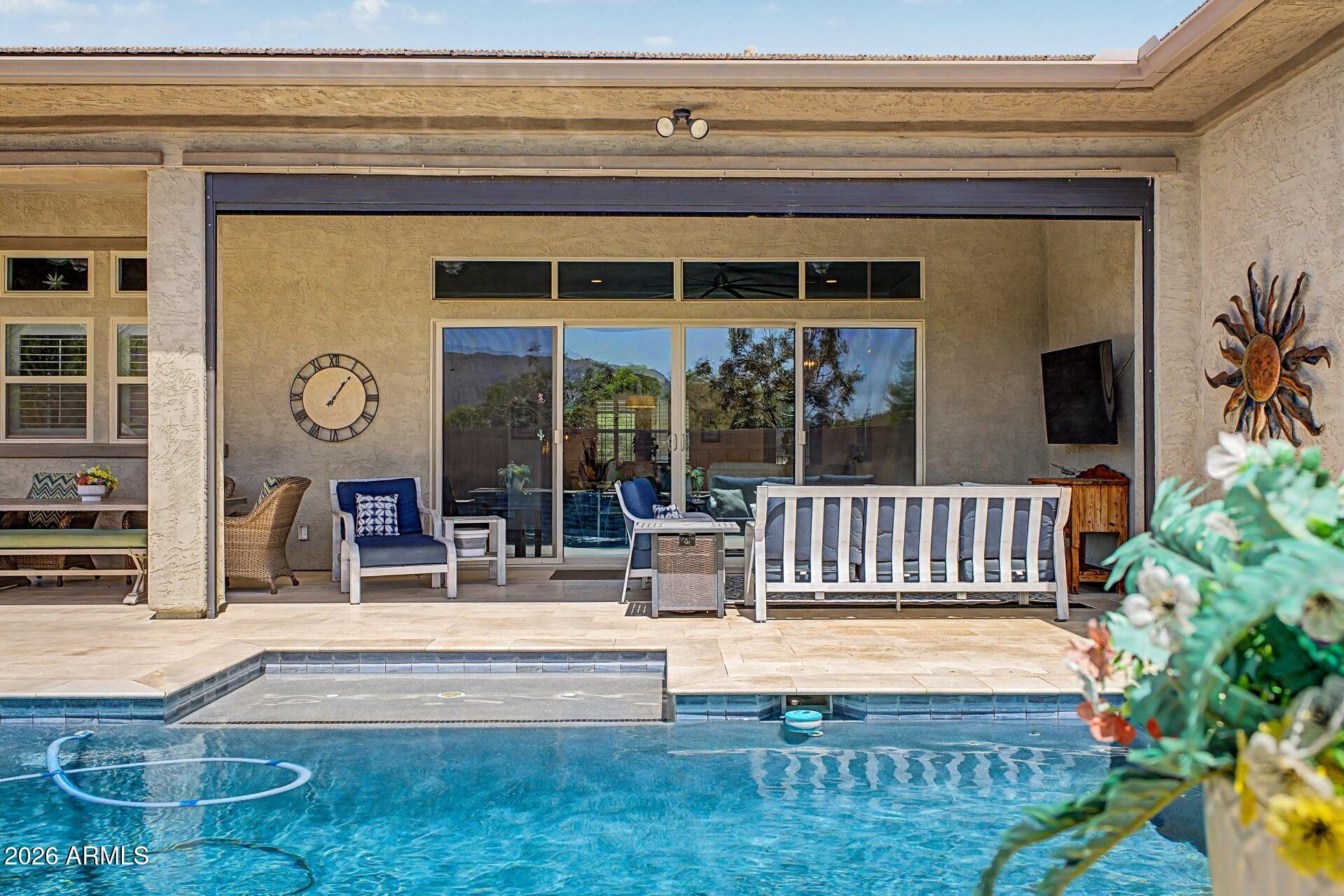 Welcome to luxury living designed for everyday comfort in the highly coveted Preserve in Adora Trails. This exceptional LEED & Energy Star Certified home offers the perfect blend of elegance, efficiency & thoughtful design.
Soaring 12-foot ceilings elevate the great room, kitchen, dining room, primary suite & bathroom, w/ 10-foot ceilings throughout the remainder of the home creating an open, airy feel from the moment you enter.
The chef's kitchen is both beautiful & highly functional, featuring upper cabinet extensions, extensive cabinetry & countertop space, an oversized island, spacious walk-in pantry w/ appliance outlet, Monogram Sub-Zero refrigerator/freezer, GE Profile gas cooktop w/ double ovens, & an over-counter microwave perfectly positioned above the coffee nook.
The seamless indoor-outdoor living experience is highlighted by an expansive 16-foot center-opening glass slider showcasing breathtaking unobstructed Mountain views. Step outside to your private backyard oasis complete w/ heated pool & spa, travertine pool decking, oversized covered patio w/ retractable power sunshade, misting system, three ceiling fans, artificial turf & a putting green, perfect for your short game. 
Boasting a desirable split floor plan w/ 4 spacious bedrooms, 3.5 bathrooms, custom wood accent walls throughout & a custom barn door in the primary bedroom, this home was crafted for both privacy & entertaining. One of the secondary bedrooms features its own ensuite full bathroom, while every bedroom offers generous walk-in closets.
The spacious bonus room offers incredible flexibility to fit your lifestyle. Whether used as a playroom, second living area, home gym, media room, game room, or movie theater, this versatile space provides endless possibilities.
A private functional courtyard welcomes you through a stunning custom iron security door. Inside, designer touches include plantation shutters throughout, even in the garage! 
Additional upgrades include epoxy garage floors, custom deep garage cabinetry, EV charging port, Polaris UV whole-home water filtration & soft water system, Ring cameras, Simply Safe security system, & conservative irrigated front yard landscaping.
This is more than a home, it's a luxury lifestyle. 
Preserve homeowners enjoy full access to everything Adora Trails has to offer, including the community clubhouse, resort-style pool w/ lap lanes & splash pad, just remodeled fitness center w/ studio room offering live fitness classes, full gym, scenic catch & release lake w/ fountains, many parks, playgrounds, basketball courts, walking and biking trails, on site elementary school, weekly food trucks, & year-round community events. All included in your low monthly hoa fee. The clubhouse & lake are just a short .3-mile walk away, perfect for morning strolls, sunset walks, fitness classes, neighborhood events, or simply unwinding by the water. This unique combination creates a lifestyle that blends elevated living w/ the convenience & connection of a vibrant master-planned community.
Residents enjoy convenient access to scenic hiking trails,  restaurants & shopping, & the expansive Gilbert Regional Park which has pickleball courts, a splash pad, playgrounds, & recreational fields. The community is also located near middle & high schools, making everyday living both convenient & connected.