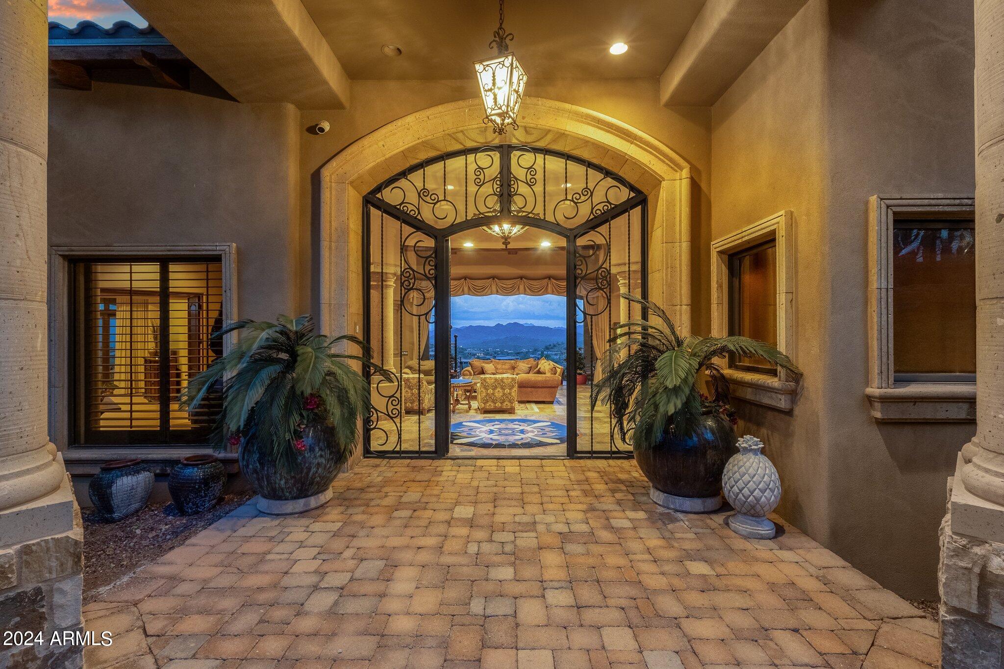 Welcome to the epitome of luxury living in Firerock Country Club!  This extraordinary PRIVATE estate, situated on 1.46 acres at the end of a serene cul-de-sac, boasts UNPARALLELED VIEWS of the first hole of Firerock Golf Course, the majestic Four Peaks, and the iconic Red Mountain. Live lavishly and entertain effortlessly in a residence crafted for trendsetters.
As you approach through the private courtyard with a tranquil waterfall, the stately foyer welcomes you with immediate views that will stir your emotions. No expense has been spared in the customization of this home. The bright and open great room features a multi-pane electric slider wall of glass, seamlessly connecting the indoors with the breathtaking outdoor PANORAMA VIEWS. The chef's kitchen is a culinary paradise, equipped with dual wood-paneled Sub-Zero fridge/freezer, two farm sinks, prep sink, two dishwashers, Wolf double ovens, 6-burner gas stove, granite countertops, breakfast bar, a pass through to the dining room, a walk-in pantry, and more. The dining room, with its decadent details and stunning views, is perfect for formal moments.
The primary retreat, abundant in space and rich in details, includes a stone gas fireplace, sitting area, and double wood sliders opening to a private deck to enjoy morning coffee and take in the breathtaking views.  The enchanting patio offers seamless access to the pool and offers captivating vistas of both Four Peaks and the majestic Red Mountain.  The primary bath offers unparalleled rejuvenation with dual sinks, lavish shower, regal soaking tub, and an oversized walk-in closet with an island and a second laundry facility.
For business or leisure, the formal study with rich wood paneling provides an elegant space.  A secondary office with built-ins complements the formal study, providing additional space for work. The downstairs family room doubles as a movie theater with a wet bar, double wood sliders, and an adjoining bedroom.
Step into the backyard oasis, where Four Peaks, Red Mountain, and the golf course create a stunning backdrop. A corner negative edge heated pool, spill-over heated spa, and swim-up bar with built-in seating enhance the experience. The oversized cabana with a fireplace, TV, and rich wood beam details is perfect for year-round enjoyment.  A synthetic grass lawn area adds versatility to the entire backyard oasis.
A separate building houses the pool equipment adding to the design integrity of the property.
Unseen but not unnoticed, this residence boasts central vacuum, an immersive indoor/outdoor home stereo system, and a water softener & R/O system.  Additional features include a convenient ELEVATOR, stone pavers, dramatic front and rear waterfalls, soaring ceilings, sunscreens, and stunning stonework. 
A separate Country Club Membership is available through Firerock Country Club.  Firerock Country Club offers 18 holes of Golf, tennis, pickleball, fitness and swimming.  Experience the pinnacle of luxury living in Firerock - where every detail is a testament to refinement.