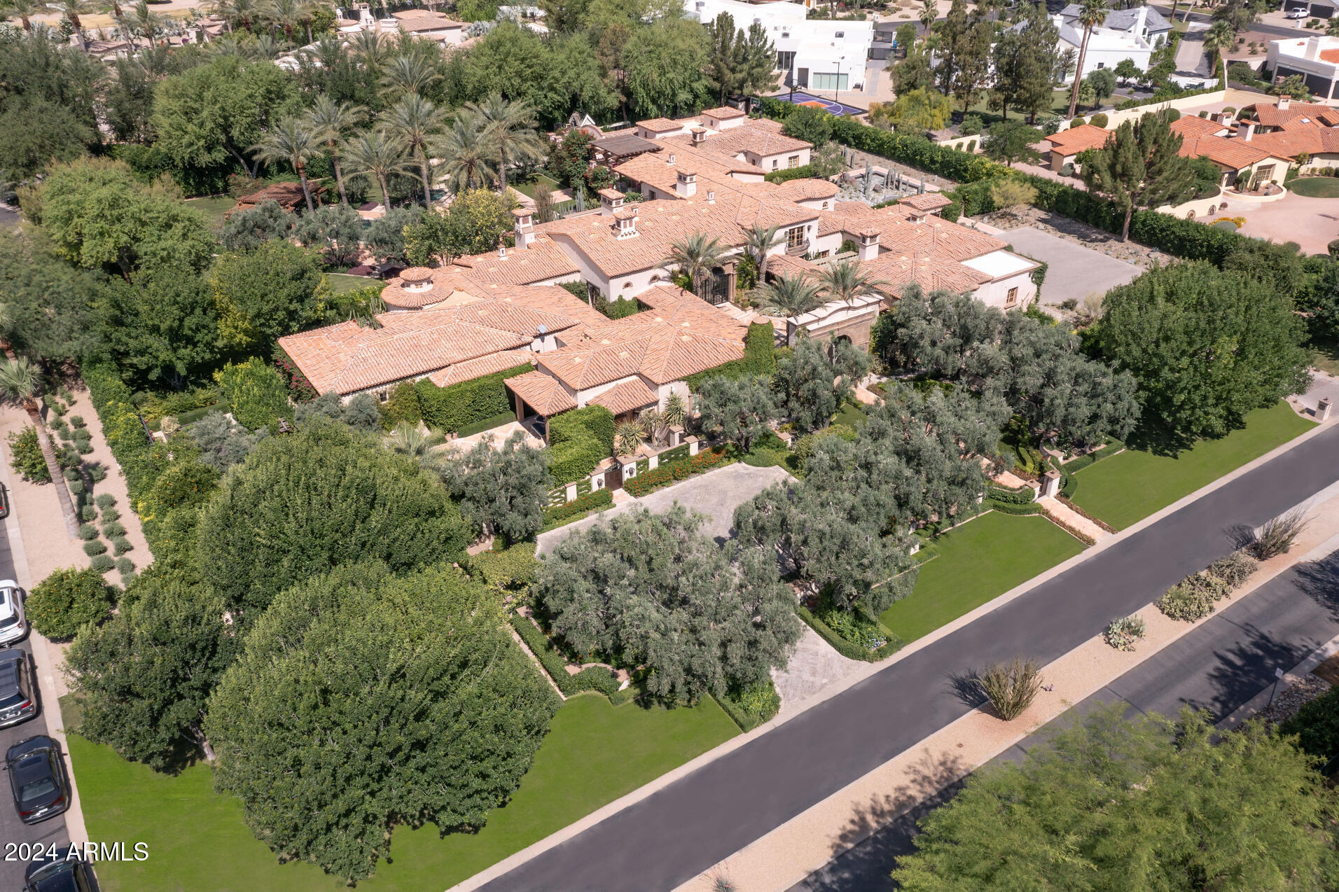 This dramatic home sits on 2.23 beautifully landscaped Acres & was named 2022 Garden of the Year by PHX Home & Garden. The estate was completely renovated and enlarged from 2015 - 2023. Interior Design by internationally renowned Matthew Boland. There are 8 ensuite bedrms including an amazing primary suite w/ 2 bathrms, wellness center + Boutique woman's closet  costing $1 Million to build. There is a kitchen w/ handmade cabinetry & dual islands, family rm w/bar, gamerm, paneled library, winerm, gym, theater + guest house. THE HOME IS SINGLE LEVEL except a 5 star guest suite upstairs.The Award Winning grounds have a Cactis + silver slate Art Installation, long lemon trellis walkway, lush lawns + mature plants, veggie garden,dining ramada, pool,+ pickle ball.