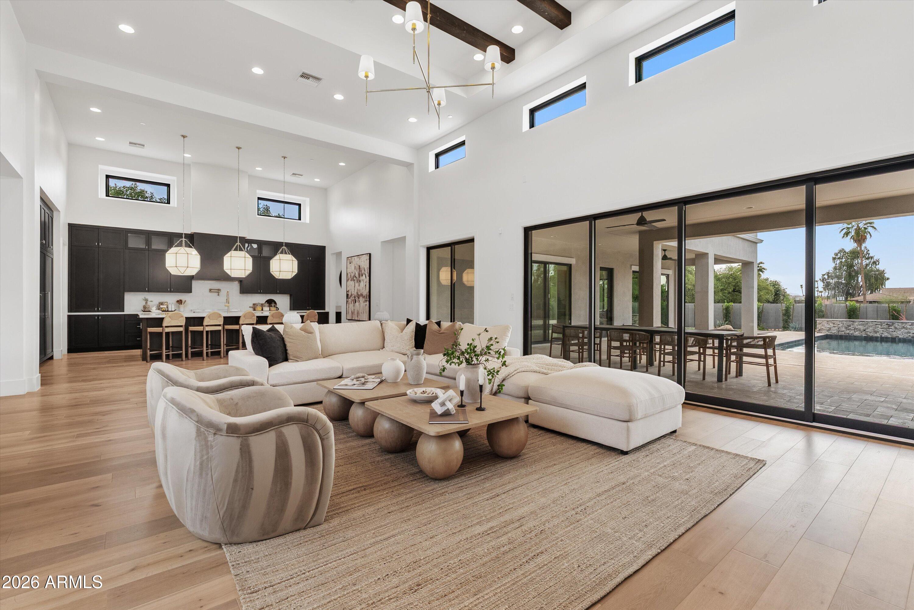 Experience the pinnacle of luxury living in this stunning new Desert Transitional estate by Thomas James Homes, ideally situated in the highly sought-after Country Club Acres neighborhood of Paradise Valley. Set on an expansive lot spanning over an acre, this architectural masterpiece offers 5 bedrooms, 7 bathrooms, a private office, and a spacious bonus room, thoughtfully designed with refined finishes and exceptional craftsmanship throughout. A light-filled open floor plan seamlessly blends indoor and outdoor living with soaring ceilings, expansive glass, and sophisticated designer details at every turn. The chef's kitchen is a true showpiece featuring Wolf and Sub-Zero appliances, a pot filler, custom cabinetry, and elegant gold hardware, all flowing effortlessly into the great room and dining spaces designed for elevated entertaining. The luxurious primary suite offers a serene retreat with spa-inspired amenities and beautifully curated finishes. Outdoors, enjoy resort-style living with a sparkling pool and spa, built-in BBQ, fire pit, and multiple gathering spaces surrounded by lush landscaping and mountain views. Located within the coveted Cherokee, Cocopah, and Chaparral school boundaries the highly sought-after "3 C's" this exceptional residence offers a rare opportunity to own a brand-new luxury estate in one of Paradise Valley's most prestigious neighborhoods.