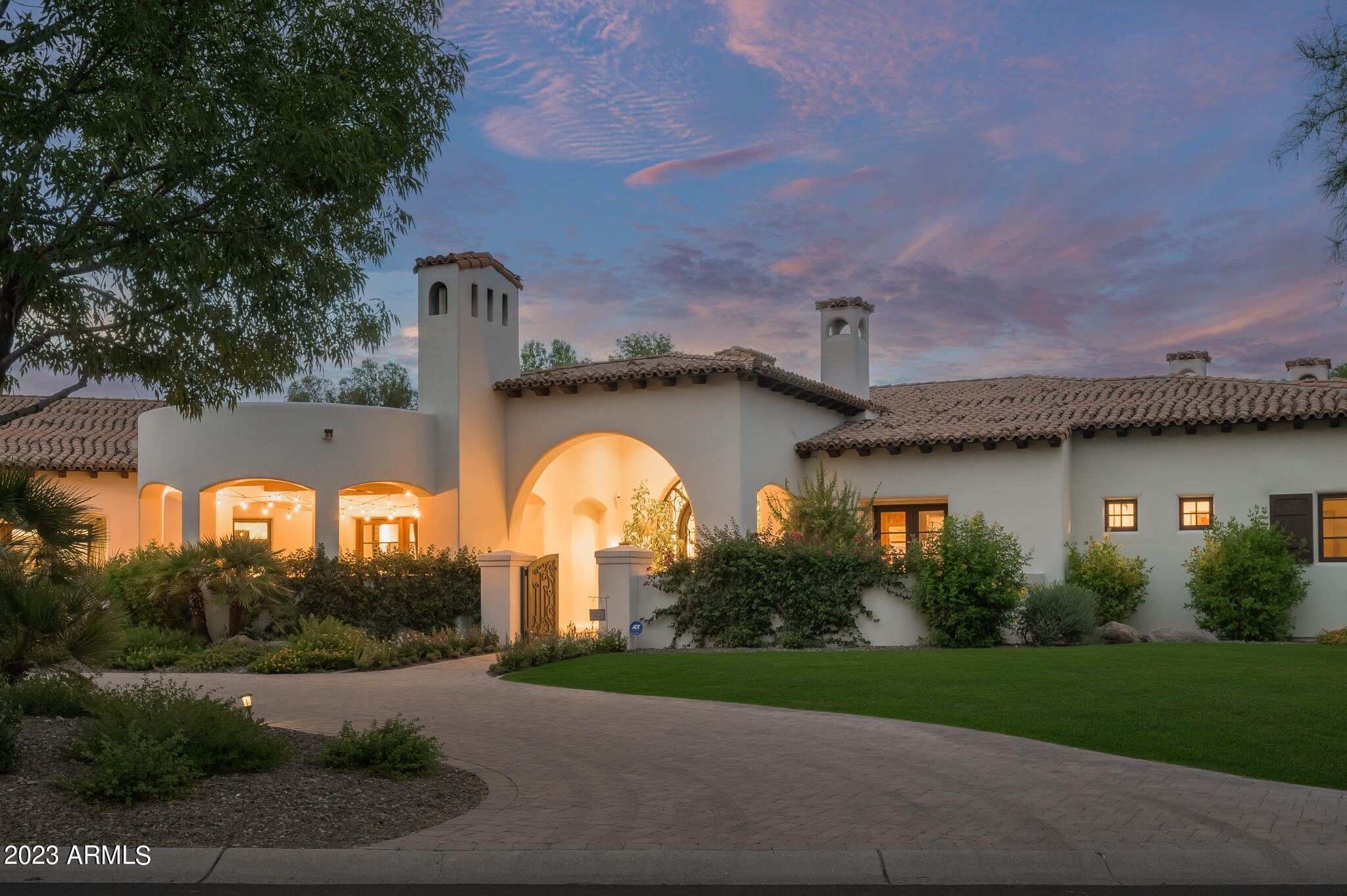 Tastefully Update Santa Barbara Home in the highly sought-after Equestrian Trails neighborhood within Paradise Valley! The meandering street of Caballo Drive is reminiscent of a Montecito neighborhood with beautifully manicured yards and stately homes, giving you the peaceful and serene feeling as you approach this phenomenal property. Thoughtfully constructed by Catalina Custom Homes, you will find one of the most functional floorplans with a wonderful master wing, guest wing, and common areas in between. The owners have enhanced the home to its current state with delicious French Oak flooring done in a dark matte finish, a light/bright chef's kitchen, bar, and great room, with wonderful accents throughout the home. Once you arrive at the property you are greeted by a generous covered courtyard with views of Mummy Mountain, a private fireplace, and multiple seating destinations. Inside, you are received by a large foyer and formal living room with wonderful ceiling details and views to the pool outside. At the East wing of the home, you have a well appointed executive office with wood detail and a private patio space. Opposite the office you will find the primary suite that checks all the boxes, from a large living area to a primary bathroom with two walk in closets, a gym, two water closets, a soaking tub, a gas fireplace, and a massive wraparound shower. From the primary suite you are taken down a sconce lined hallway that gives access to the formal dining room with beautiful brick work upon the ceiling, and the wonderfully redesigned great room which encompasses the family room, bar area, breakfast nook, and new kitchen with phenomenal appliances and 3 dishwashers. Down the secondary corridor you are brought to a large secondary family room/common area that has three large en-suite bedrooms that feed into this area. The home also features an attached casita with a kitchenette(refrigerator, microwave, and dishwasher), great size bedroom with a gas fireplace, and an oversized bathroom with a tub and shower. The laundry room embraces storage with walls of cabinetry, hanging space, 2 washers, and 2 dryers. Throughout the home you will notice beautiful stone detail around all of the 7 fireplaces, 5 on the interior and 2 on the exterior. The property sits on just over 1.1 acres allowing for each room to have a private patio space, and the backyard to have a large diving pool with a massive grass yard space.