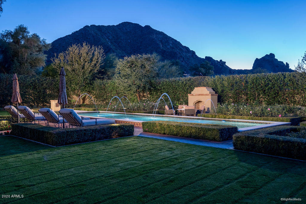 This timeless Mediterranean home sits quietly on the best lot in Finisterre with stunning views of Camelback Mountain and the Praying Monk. The exceptional floorplan has a split master, a very private guest wing and a spacious guest house that doubles as a perfect pool cabana. While gracious, the home feels more intimate and cozy than its square footage suggests. Updated finishes  include stone and Hickory hardwood flooring, plank and beam ceilings, high-quality custom cabinetry and much more. Sought-after landscape architect Jeff Berghoff implemented a gorgeous outdoor environment that will leave you speechless. With block construction and a private cul-de-sac setting in Paradise Valley's most exclusive gated community, this high-quality opportunity won't last long.