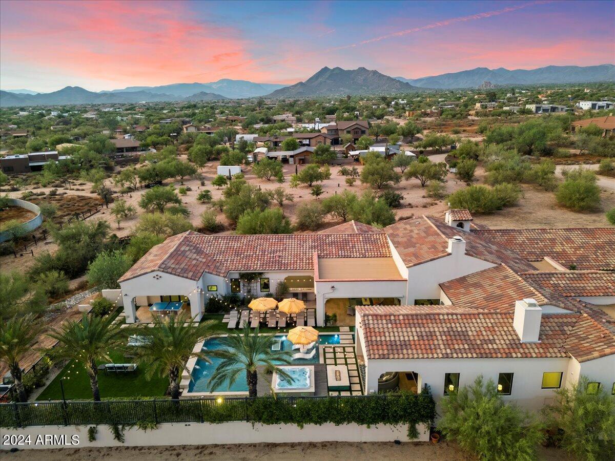 If you are looking for a sanctuary, this may be the home for you. When you walk in the door, your cares melt away. Every detail custom designed to bring calm and serenity. Listen to the rhythms of the desert or curate your own with surround sound throughout the home. This turnkey property has everything you need to entertain, work, and play. The resort style backyard has a hot tub and heated pool with fountains and fire tables to wow your guests. The gym and oversized office make productivity and healthy living a breeze. All of this, just minutes away from everything that North Scottsdale has to offer. Exceptional finishes and privacy, all without sacrificing convenience. This beautifully appointed home can be sold with furnishings on a separate bill of sale, making your move effortless. Exceptional Features Include:

Primary Suite: Features a jetted tub with a see-through fireplace, his and hers walk-in closets, safe room, and laundry.

Wine Enthusiast's Dream: Savor your finest vintages in the temperature-controlled wine cellar or beverage center, complete with marble countertops, dual drawer refrigerators, and two built-in ice and water dispensers.

Gourmet Kitchen: The main kitchen is a chef's delight, showcasing white marble countertops, an island with stunning leathered granite, built-in appliances, a walk-in pantry, and a convenient pass-through window to the outdoor patio.

Entertainment Haven: Host unforgettable gatherings in the resort-style backyard, boasting a reflection fountain, a sparkling pool, a sunken hot tub, and an outdoor kitchen with a fire table. Enjoy the seamless indoor/outdoor living experience facilitated by the impressive 20-foot pocket door.

Custom Interiors: The great room features high ceilings with faux wood beams, custom pendant lighting, a striking gas fireplace with stone veneer and fiberoptic twinkling lights, and engineered wood floors.

Executive Office: A spacious executive office accommodates two workspaces, perfect for those working from home.

Pet Paradise: Pamper your pets in the dedicated dog room with a shower, leading to an outdoor dog run enclosed by block walls with deep footers and a steel mesh view fence.

Smart Home Features: Enjoy the convenience of motorized shades both indoors and outdoors, wood casement double-pane windows, and comprehensive home automation systems.

Energy Efficiency: Benefit from spray foam insulation, three tankless water heaters, whole house filtration, soft water system, hot water recirculation, and three HVAC units with air scrubbers and humidifiers.

Safety and Security: Peace of mind is ensured with surveillance cameras, an alarm system, fire sprinklers, and a 500-gallon LP tank.

Garage and Storage: The oversized three-car garage includes an electric vehicle charger and a storage room, providing ample space for all your needs.

This magnificent property offers breathtaking sunset views from almost every room, mature date palm trees, a large artificial grass area, a stereo system, and a misting system for year-round outdoor enjoyment. This spectacular estate embodies the essence of luxury living and is a must-see for those seeking the finest in desert living.

Experience the epitome of luxury in Cave Creek.