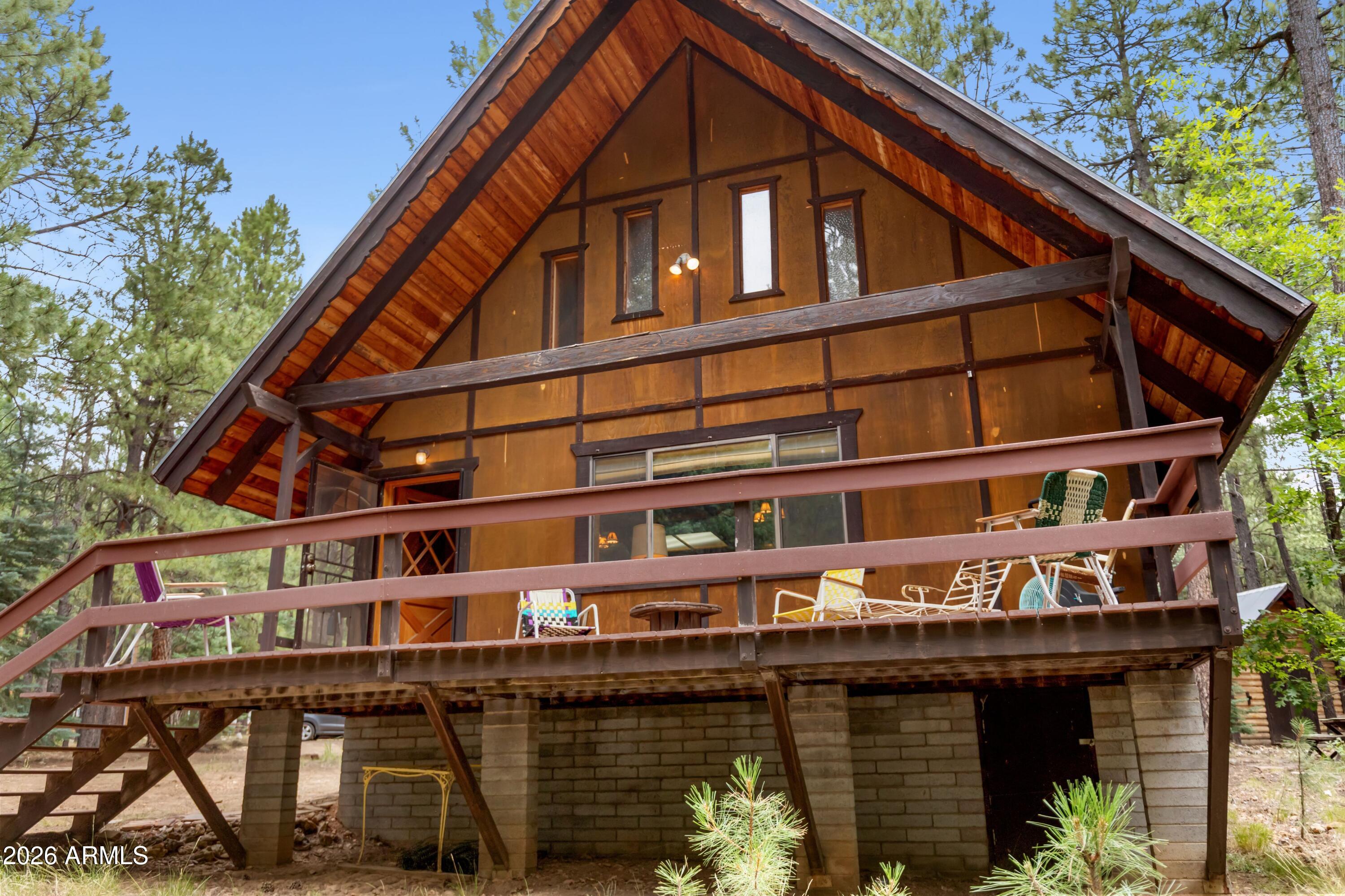 Welcome to your dream mountain escape! Nestled on a rare, sprawling 1-acre lot in the highly sought-after Forest Lakes community, this charming 2-bedroom, 1-bathroom cabin offers the perfect blend of rustic comfort and pristine nature. Built in 1981, the home features a cozy, timeless cabin feel with plenty of room to breathe.

The crown jewel of this property is its unbeatable location--directly backing the majestic National Forest. Step out your back door into endless scenic views, towering pines, and peaceful wildlife. The massive lot provides ultimate privacy and includes 2 large storage sheds, perfect for all your mountain toys, tools, or workshop needs. Whether you are looking for a cool summer getaway or a cozy winter retreat, this forest-side gem is ready for its next chapter.