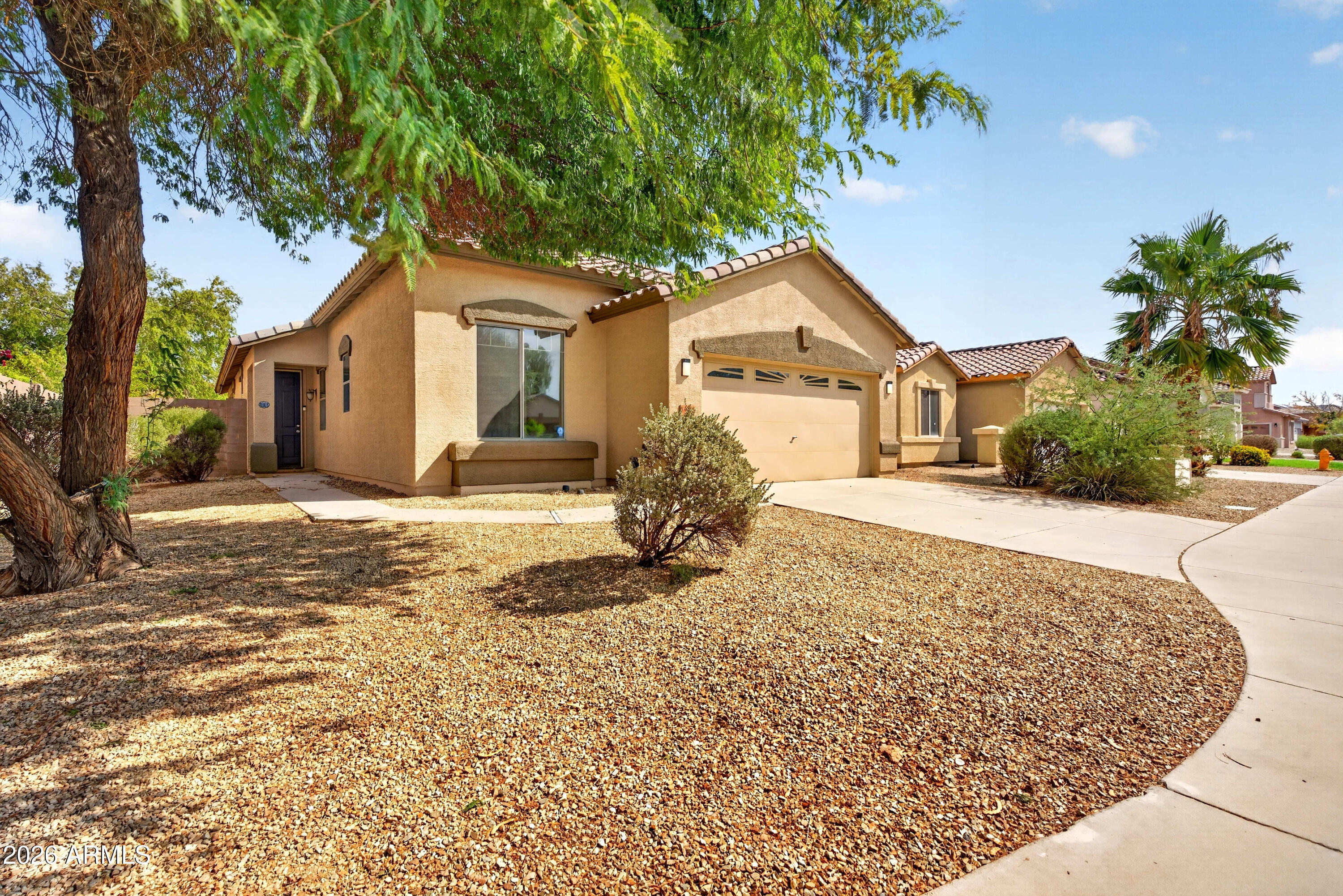Discover easy living in this beautifully maintained 3-bedroom, 2-bath home with low maintenance landscaping and a bright open floorplan. The spacious living room flows into a well-appointed kitchen featuring stainless steel appliances, a large island, breakfast bar, pantry, and dining area. The private primary suite offers a walk-in closet, double vanity, soaking tub, and separate step-in shower. Relax outdoors under the covered patio or enjoy the additional patio space and low-maintenance artificial turf backyard. Community amenities include walking and biking paths and a children's playground. Don't miss this incredible opportunity!