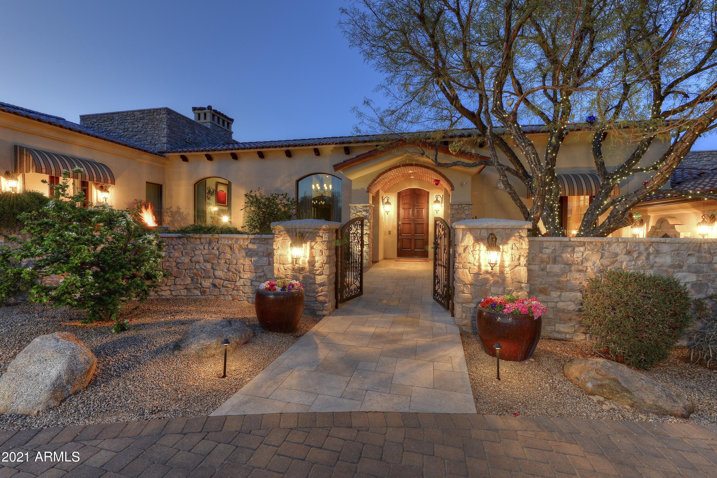 Transitional European style w/ classic interiors (by Beth McGehee) highlight the impeccable quality throughout this romantic property. Lovely patios overlook fountained pool, & Camelback Mtn. silhouette.  Master Suite offers serenity & romance w/ Juliet balcony, quiet sitting area by the fireplace, & fabulous bath and closets. Second Master Suite opens to private patio w/ firepit, dramatic views of Camelback. The comfortable library is a favorite room, w/ full wetbar, fireplace, beautiful custom built-in bookcase.  Living Room/Great Room showcases tall picture windows, beamed ceilings, handsome wood floors.  Dramatic barrel vaulted ceiling in formal D/R, temp. controlled wine storage, & French doors opening to courtyard fountain.  Kitchen and family room are open & light w/ every amenity!