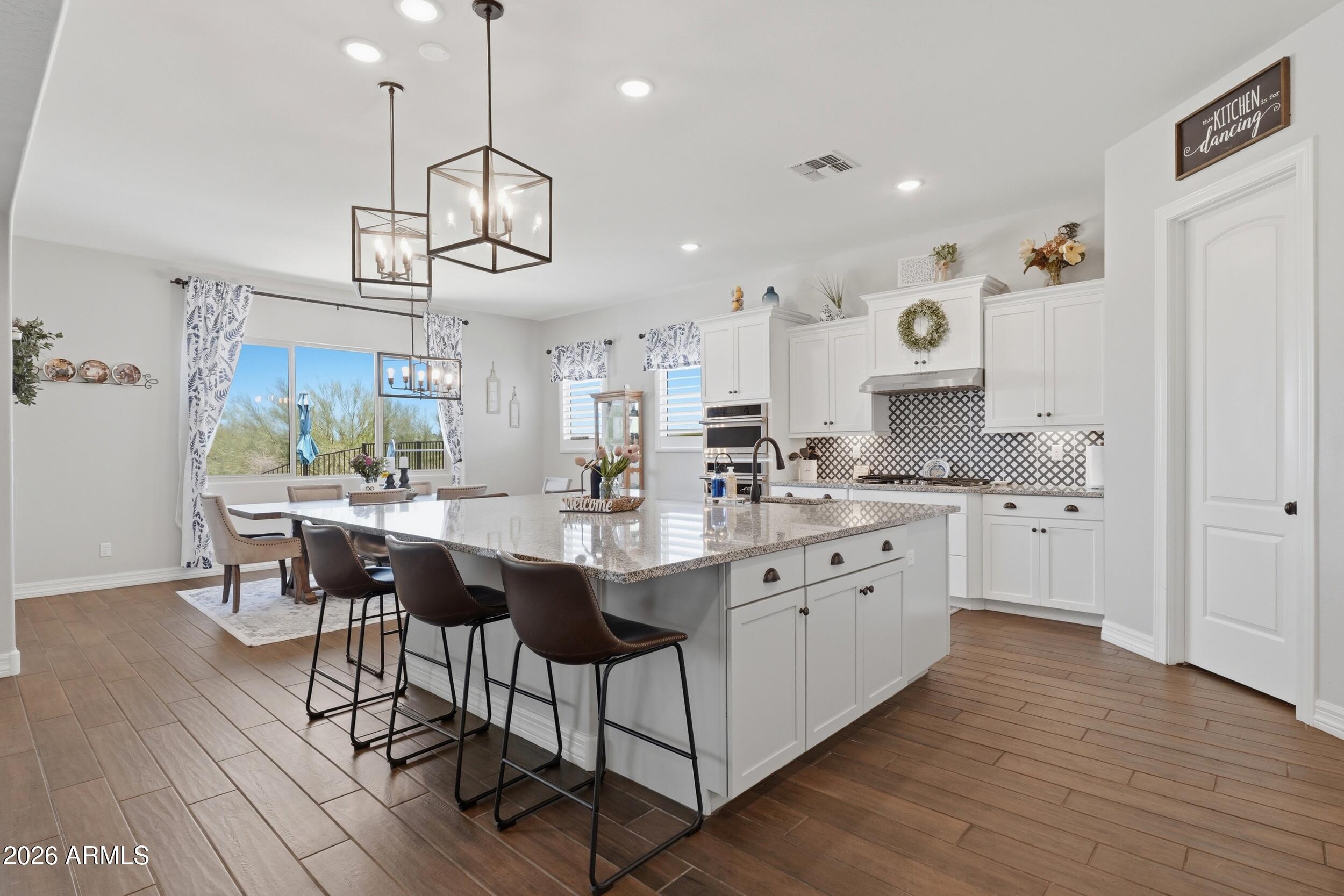 Located inside an exclusive gated Waddell community near the White Tank Mountains, this original-owner home offers privacy, space, and an elevated West Valley lifestyle. Set among huge custom homesites with generous separation between neighbors, the property is designed for those who value peace, privacy, and room to breathe. A paver driveway and walkway create a polished arrival, while 10-foot ceilings, 8-foot doors, and a 3-car split garage add scale and everyday function. The backyard now features a brand-new pool just installed by the owners, creating a fresh outdoor setting for relaxing, entertaining, and enjoying Arizona living. With easy access to Surprise and the broader West Valley, this home offers a rare blend of gated privacy, mountain proximity, and convenience.