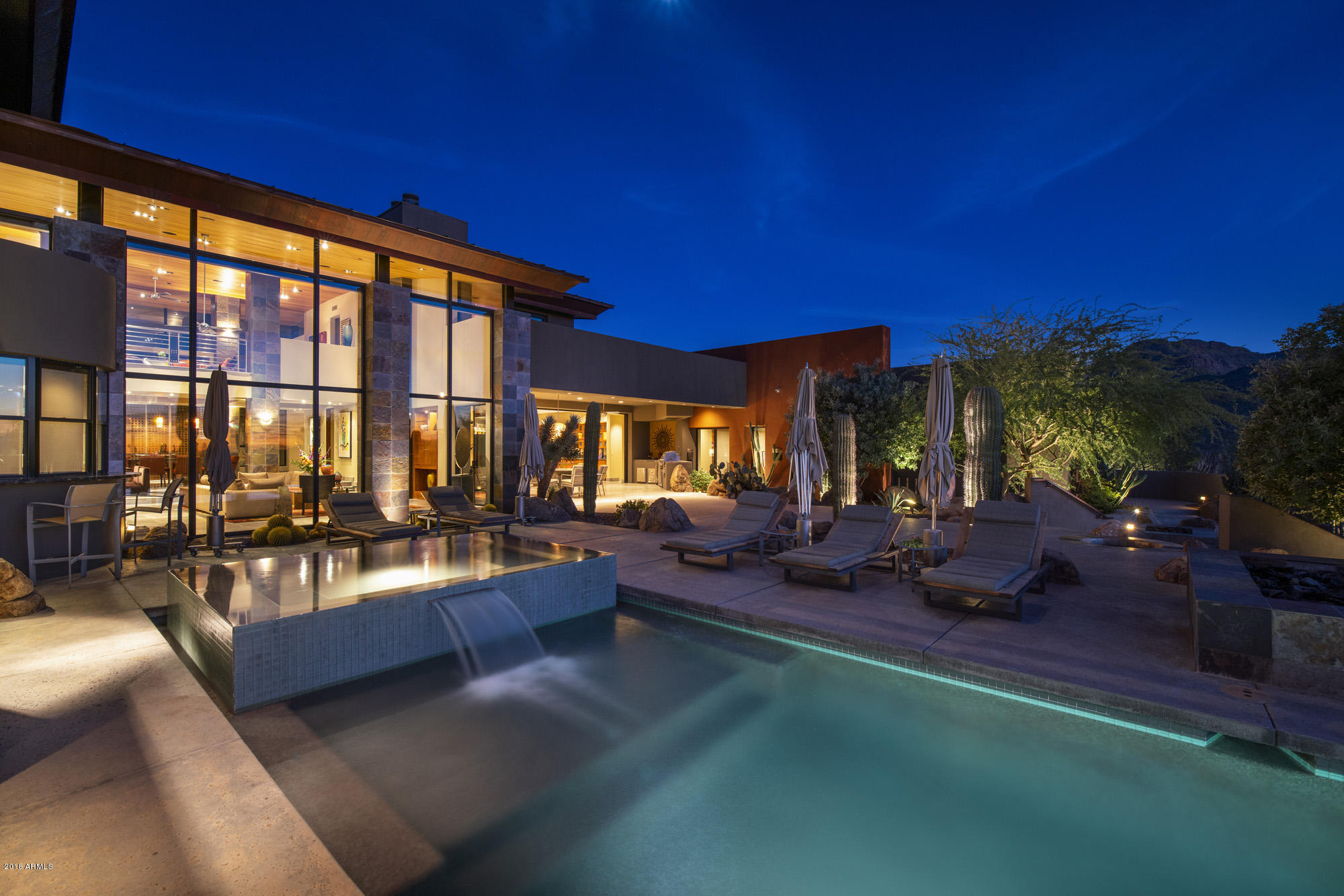 Enter this contemporary estate that sits on a very secluded 2.6 acre view lot in the heart of Pinnacle Peak area & prepare to be amazed. This Bing Hu contemporary stunner is located in the highly sought after gated enclave of homes called ''Canyon Heights'' -featururing a 9124 SF main home with a 12 car garage, a 2 bdrm/2 bath attached guest home, & a sep. caretaker's quarters with it's own 1 car garage.  The main home features 4 ensuite bedrooms, 2 separate game rooms (1 in the kids' wing & 1 for the public part of the home), a lg. beautiful office & a master loft. The new owners are sure to love the amazing soaring high ceilings through out the home & the amazing floor to ceiling walls of glass overlooking the resort style backyard with the incredible negative edge pool & spa, multiple water features, multiple firepits, & a full sized tennis court. This contemporary estate exudes the high level of outstanding design, high end finishes, & A+ construction you have come to love & admire from world reknown, award winning architect Bing Hu. The Chef's kitchen is pure joy with the open floor plan to the breakfast nook & light, bright airy family room.  Additionally the new owners will delight in using the highly upgraded appliance package that consists of side by side Sub-Zero refrigerator/freezers, double stainless steel dishwashers, double Dacor wall ovens, a Dacor warming oven, & a 6 burner Viking cooktop.  This gourmet kitchen features custom wood cabinetry and designer slab granite counter-tops.  Buyers will find the floating circular stairway w/ metal railings that leads up to the impressive master suite simply stunning!  The master suite is a spectacular retreat with amazing mountain views in every direction from all of the large windows & private balcony. The master bedroom features a beautiful gas fireplace and the master bathroom boasts separate HIS/HER vanities with custom granite slab counter-tops, a lg. walk-in shower, beautiful jacuzzi tub, and separate HIS/HER walk-in closets. The master suite also has a lg. private library/loft with mountain & desert views from every inch of this fabulous space!The secondary wing of the home features 2 ensuite bedrooms both w/ walk-in closets & a kid's game room in between the 2 kids' bedrooms. Car collectors will fall in love with this car collector's dream 12 car garage w/ a special viewing window to view your trophy cars from the main game room & spacious office.  The attached but separate guest house is ideal for the extended stay guests with a full kitchen, family room, 2 separate bedrooms & 2 bathrooms plus a private patio with beautiful mountain views. This one of a kind custom contemporary masterpiece sitting on 2.6 pristine acres of prime Scottsdale property can now be yours for the amazing price of $4,995,000!!