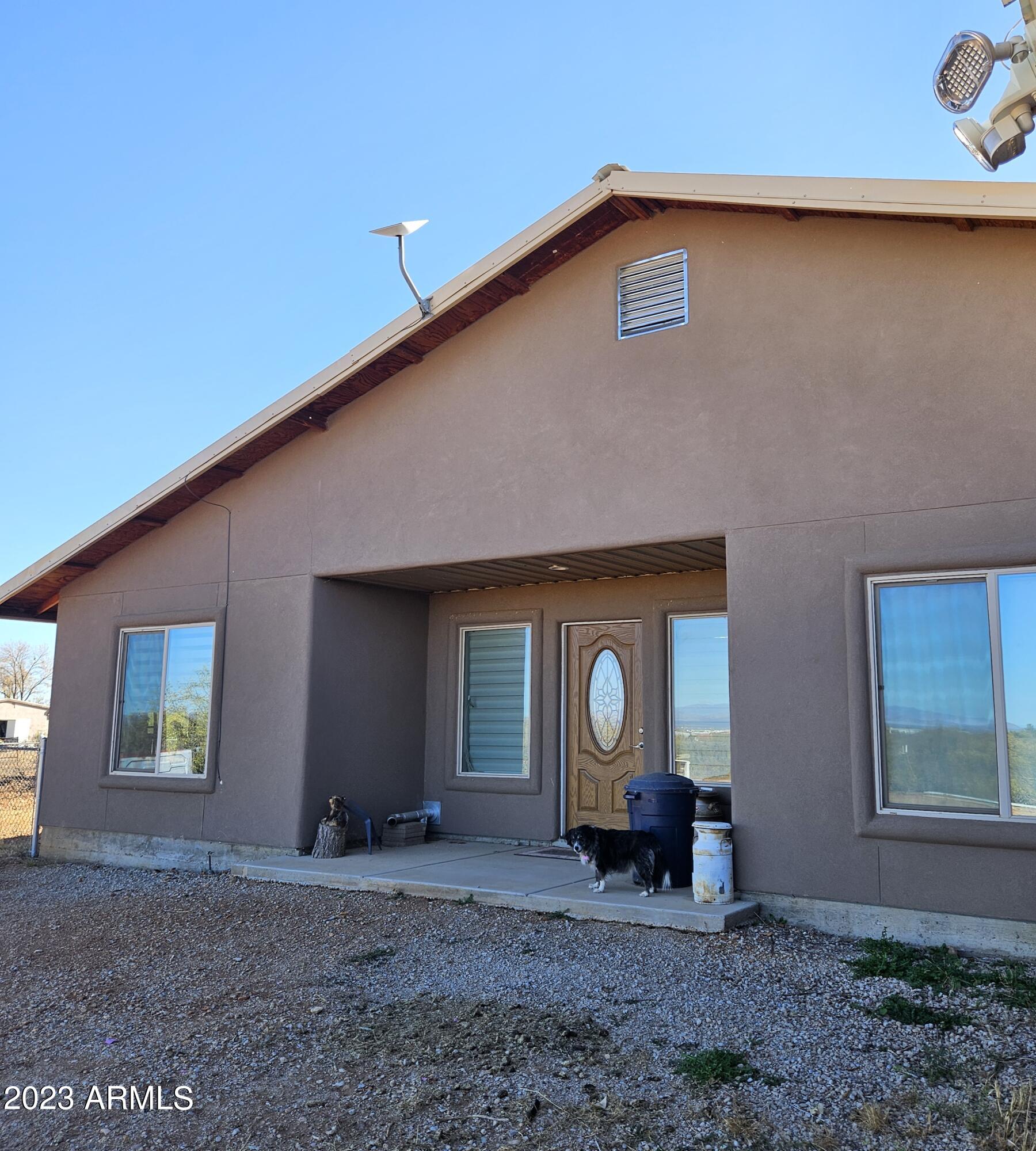 Custom built in 2017 with Metal Roof and 2x6 walls. Home is on horse property with a little something for everyone! Newer home with new private well in early 2023. 3 bedroom plus bonus room now being used as huge walk in pantry. 2 1/2 baths. Open great room concept. Pellet Stove to heat living area. Enclosed sun room. Huge primary bedroom with 2 walk in closets! Guest house with Kitchenette and bath.. Plus another partially finished shed with AC.. Quonset hut workshop with large covered breezeway attached with 40 foot Conex box for additional storage. Also has 2 additional  20 foot Conex boxes with metal roofs.. One being used as a horse shelter and feed room. The other is a tackroom and has a hitching post and a porch.