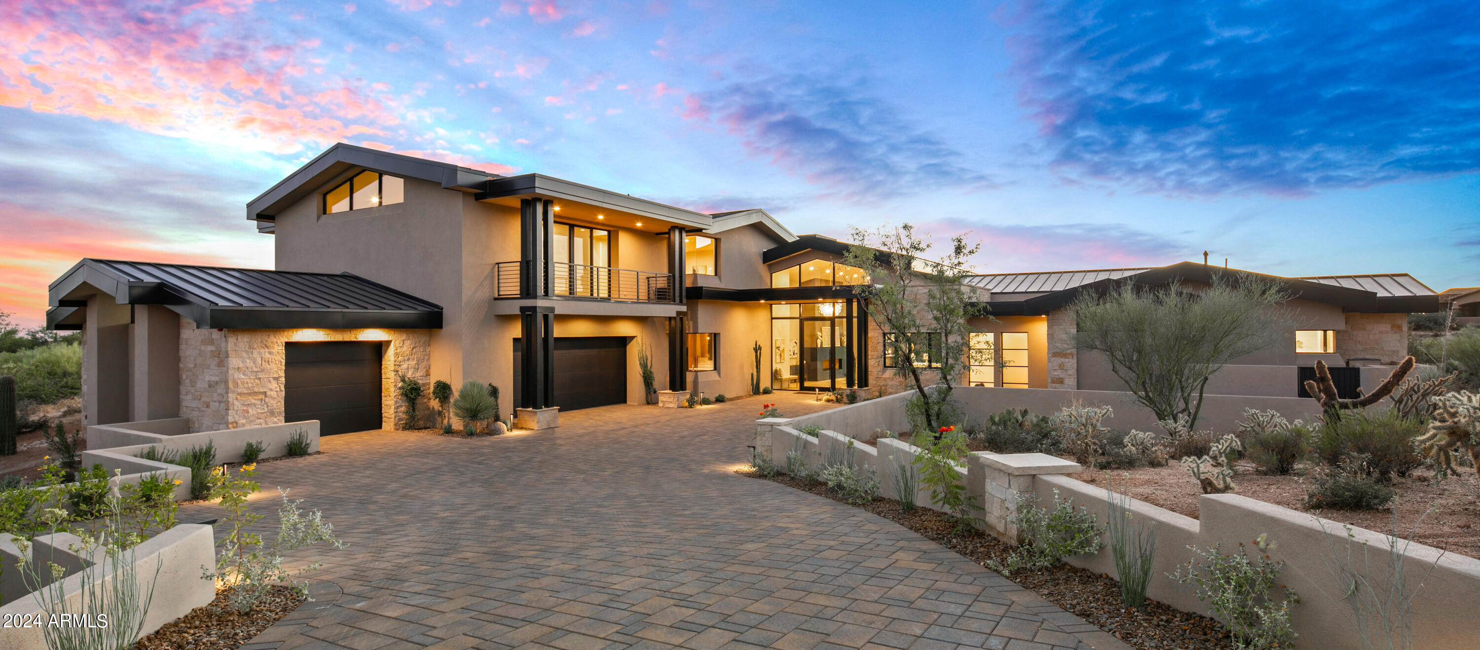 Cutting edge new build by Red Moon Homes.  Located in the exclusive North Scottsdale private community of Mirabel.  Contemporary design, all on one level with an upstairs guest home reached by an impressive cantilevered lighted wood slab tread and steel beam U shaped lighted staircase. To die for spacious outdoor living to enjoy with modern pool with sizeable beach entry and adjacent spa, covered grilling, living and alfresco dining space. The cool and clean look of artificial turf is plentiful and easy to care for. Modern minimalist exterior with stucco, rough limestone stack stone details, multitudes of glass doors and windows, metal roof and facia with multiple vaulted roof lines.  The flawless floor plan with an open, high ceilings, airy great room, dining, kitchen, wet bar and powder provide for daily living as well as festivities with many.  The private split primary sanctuary with cutting edge finishes, spa like bath, massive designer closet and patio access will delight.  The nearby ensuite barn door entry office provides an exemplary workspace or can serve as a 5th ensuite guest room. Close proximity to the decadent laundry with mitered window detail and to the beautifully finished 4 car spic and span garage space, entices all.  For family and friends the two guest ensuites on the main level provide privacy and elegance, wonderful retreats, one with patio access.  The upstairs guest home is not to be believed.  The sitting space, ensuite bedroom, living space with powder and breakfast bar complete with sink and faucet enchant.  The North and South balconies, through 4 paned glass wall systems bestow elevated panoramic views of mountains, city lights, sunsets and starry skies. Sophistication is viewed throughout with the finest of finishes - new sizeable porcelain tiles used on bath floors and walls, wide wood plank floors throughout, SubZero and Cove appliances, rift cut and lacquered slab cabinetry with lit toe kicks, fabulous top of the line exotic Quartz counter and vanity slabs and chrome and the new brass hardware. Mirabel's intimate community offers, golf, tennis, fitness and social endeavors. Come, live the Arizona desert lifestyle with comfort, opulence and functionality in this magnificent Red Moon Homes built Mirabel home.