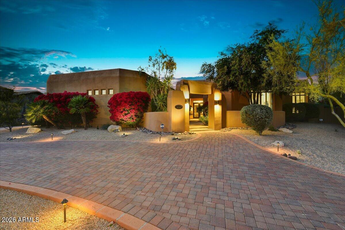 Tucked within the prestigious Pinnacle Peak area, Pinnacle Peak Country Club offers an exceptional blend of privacy and refined desert living. Set on nearly an acre, this meticulously remodeled Great Room home showcases thoughtful design, elevated finishes and seamless indoor-outdoor flow. This home features 3 bedrooms, 3.5 bathrooms, a dedicated den/office & an expansive TV/Media room. Entry begins through a private courtyard and glass front doors revealing a stunning backyard framed by mature desert landscaping, a resort-style play pool with water features & spa, a pergola and an outdoor fireplace. Inside, soaring ceilings and curated, high-quality finishes define the home's modern Southwestern aesthetic. The open-concept Great Room/Kitchen create a spacious & welcoming environment .... ...ideal for entertaining and family gatherings. Despite it's serene and peaceful setting, the home is just minutes from premier dining, shopping and convenient access to the Loop 101- offering the perfect balance of quiet luxury and central convenience within this sought-after community.