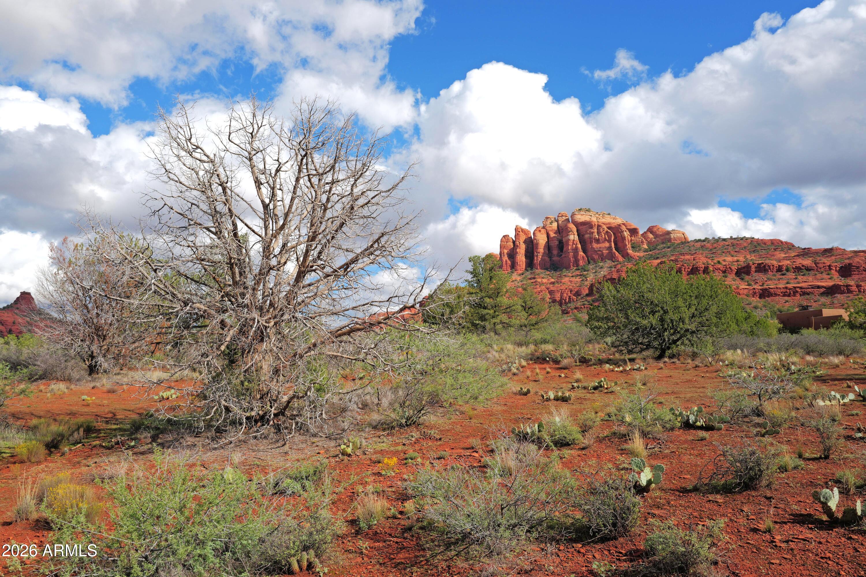 Enter a gated enclave of beautiful homes, with stunning Red Rock views, nestled in the confines of the Coconino National Forest. Enjoy multiple trails & access to the Red Rock Crossing/Oak Creek swimming spot. Lot is located on a pristine cul-de-sac, with no topographical or drainage issues to hinder future construction. Building Envelope size is based on 32% of gross Lot size = 22,999 S.F. Min: House size of 2,100 S.F. Also there are no existing or anticipated obstructions to hinder your Red Rock views. Beautifully maintained interior roads and well managed HOA. Min: 30-day rental. Minutes from suppport services in the Village of Oak Creek (Clark's, Sedona Athletic Club, 2 great golf courses, and a variety of  fine restaurants). Easy access to Interstate 17.
